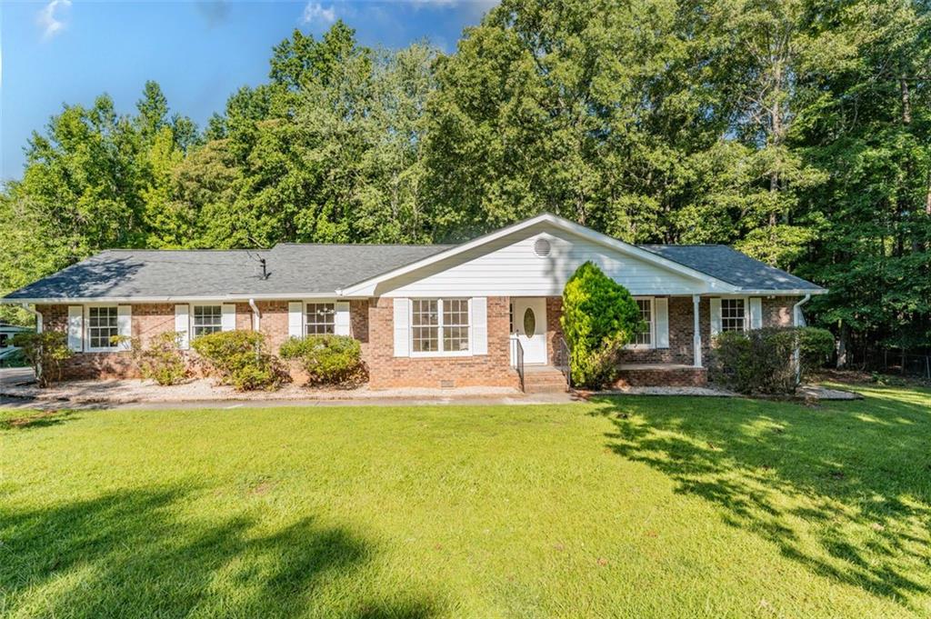 This beautifully renovated home sits on 1.01 acres and blends modern comfort and style with pops of vintage charm throughout. Enjoy a sleek kitchen with brand-new appliances. The primary suite has two separate closets, giving each person their own dedicated space. This primary bathroom is designed for relaxation, complete with a modern spa like standalone tub, walk-in shower, and elegant finishes. The home also features a 2-car garage, extended driveway for extra parking, and two storage sheds for all your things. Relax on the patio or host on the large deck overlooking a your large private yard. Don't miss this opportunity! This move-in ready home is PRICED TO SELL! and offers the lifestyle you've been looking for!