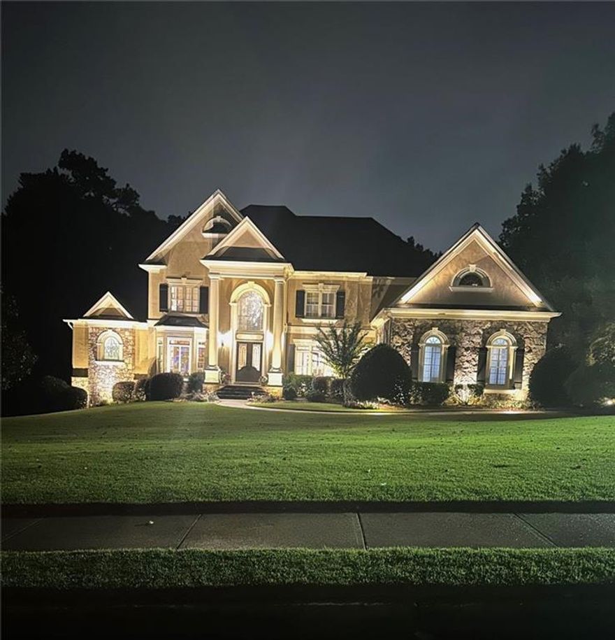 Experience resort-style living in the Northshore Gated and 24/7 Guarded Subdivision within the coveted Lake Windward Community. As you approach this European stone and stucco home, the expansive front lawn creates a grand entrance, welcoming you into luxurious living. The home offers 8,904 sqft of living space, including 6 bedrooms, 7 full baths, and 2 half baths. Upon entering the foyer, you'll feel the warmth and inviting atmosphere of your dream home, with a view of the lush backyard that beckons to explore further. The custom Brookhaven by Wood-Mode kitchen is equipped with Wolf, Subzero, and Dacor appliances, a 10' Walnut Island, and granite countertops. The main level primary suite features a spa bath, a spacious walk-in shower with an over-head fixture, and custom-designed closets. The lodge-themed terrace level includes 2 full bathrooms (one designed for pool guests with a grotto-style experience), a wine cellar, a stone bar, a bedroom currently used as a fitness room, a media room, a hobby room, and storage. The outdoor oasis includes a saltwater infinity pool with a waterfall spa, a flagstone patio with a stone fireplace, a composite deck, an underdeck system, and a wrought iron fenced yard. The roof was replaced in 2017. Recent upgrades include new chandelier light fixtures, living room glass shelving, new carpet in the primary bedroom, media room platform, large screen, theater video equipment, theater lounge chairs, and outside lighting. This meticulously maintained home, nestled on a 0.71-acre lot in a serene cul-de-sac, seamlessly combines elegance and comfort, making it perfect for a luxurious lifestyle.