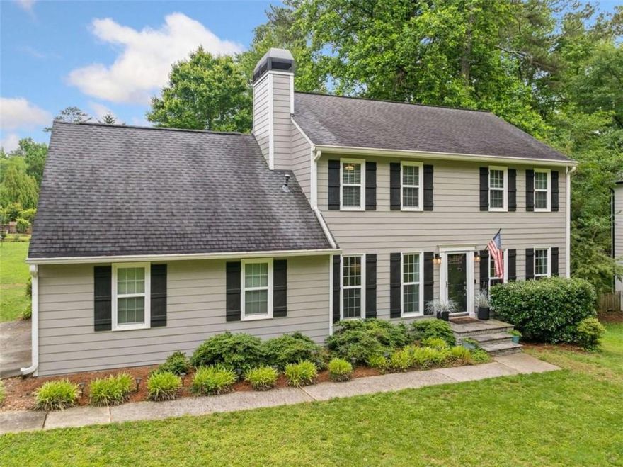 East Cobb Beauty in Superb School District and friendly swim/tennis community. Dreams do come true! Lovely traditional with fabulous grassy backyard.  Concrete siding exterior - Master Bath updated. House has been replumbed. Majority of windows have been replaced. Granite countertops in Kitchen, Master Bath and Secondary Bath. Updated Powder Room too. Newer Light Fixtures. House has been re-plumbed. Oversized Entertaining Deck - low to the ground - for endless hours of outdoor fun. Primary retreat and two Spacious secondary Bedrooms upstairs ... PLUS versatile bonus room/office. Side entry garage. Large laundry/mud room. This beautiful home is ready for you. Popular community offers clubhouse, pool, tennis, pickleball and planned social events. This is a great home for making wonderful memories. Hurry to see.