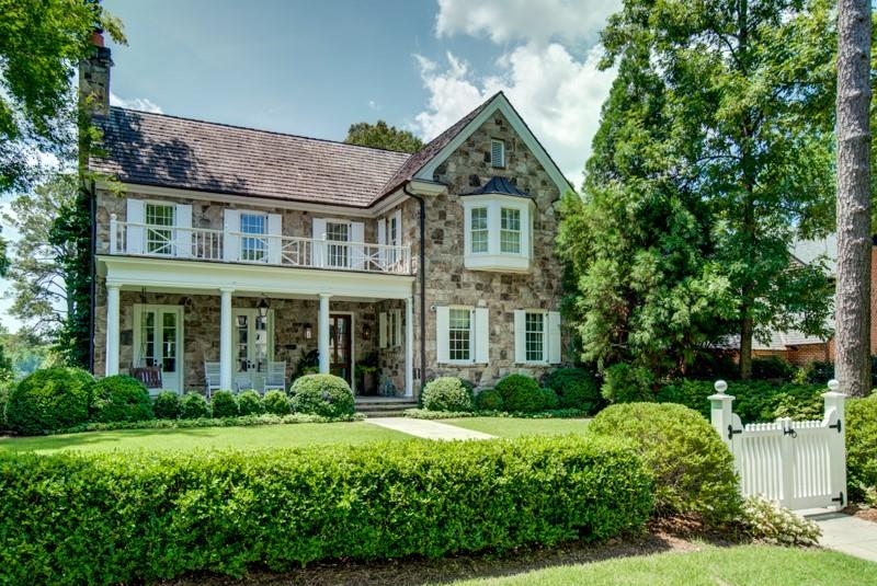 This thoughtfully designed custom home by Yong Pak & Associates underwent a full renovation in 2018 by Mike Hammersmith, and gorgeous interior design by Kay Douglass Interiors. Generous foyer opens to formal living room with fireplace, dining room and entrance hall running throughout the main level with an abundance of natural light. Newly renovated kitchen offers double islands with marble waterfall counters, kitchen backsplash extended to the ceiling for a dramatic look, stainless steel appliances and opens to the breakfast area and keeping room with fireplace. Southern facing walls of the home feature iron doors and windows bringing in tons of sunlight, opening up to a convenient grilling deck and covered porch just off the kitchen and keeping room, with easy access to the backyard and pool. Spacious guest bedroom with en-suite bath on main as well, overlooking the courtyard with water feature and fireplace. The grand staircase leads to the upper level with an oversized primary suite featuring dual walk-in closets and dual baths, and a stunning wall of windows with southern facing views in the treetops. 3 additional spacious bedrooms, 2 bathrooms and laundry room on the upper level as well. Fully renovated terrace level is encased in shiplap and consists of a state-of-the-art gym, full bath, recreation room with fireplace, laundry closet conveniently located to the gym and pool, plus access to the 2-car garage with dog wash station and large storage rooms. Iron French doors lead from the terrace level to the covered patio, backyard and pool areas as well. Beautifully manicured grounds with mature landscaping by Land Plus including saltwater pool, covered gazebo and courtyard with water fountain. This home has a traditional front exterior with contemporary interior finishes offering a perfect blend. Truly a must see home on a great street in Haynes Manor. Just steps away from the Beltine, Bobby Jones and E. Rivers Elementary.