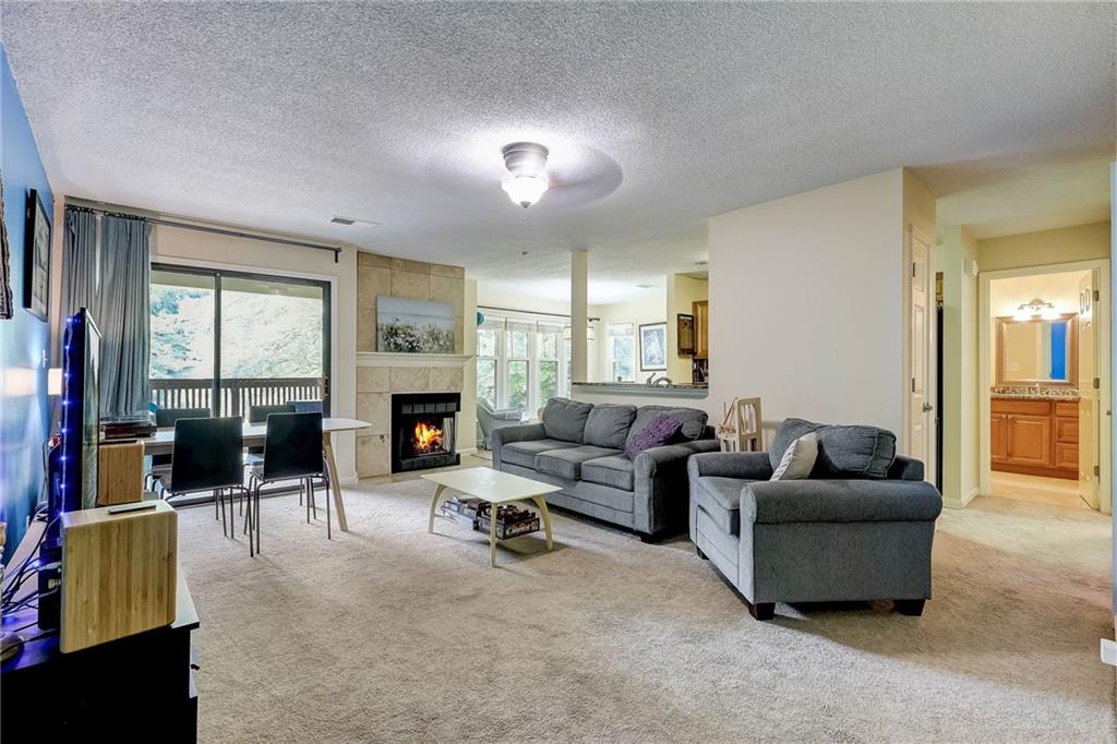 Welcome to Dunwoody Springs, an amenity rich community in sought-after Sandy Springs. This desirable top floor end unit offers the best view in the complex overlooking a tranquil pond and lush trees, providing the perfect blend of nature and privacy. The open floor plan features an updated kitchen with granite counters and stainless-steel appliances. Walls of windows flood the space with natural light creating a warm and inviting feeling. Both bathrooms have been tastefully remodeled with tile showers and granite vanities. Step out to the covered porch, an ideal spot for morning coffee or unwinding after a long day. Enjoy the community's swimming pool, tennis courts, clubhouse and 7-acre lake. Experience the close to everything lifestyle just minutes away from MARTA, shopping, restaurants, and entertainment. All of this and a stress free commute with easy proximity to major highways. Don’t miss the 3D tour!