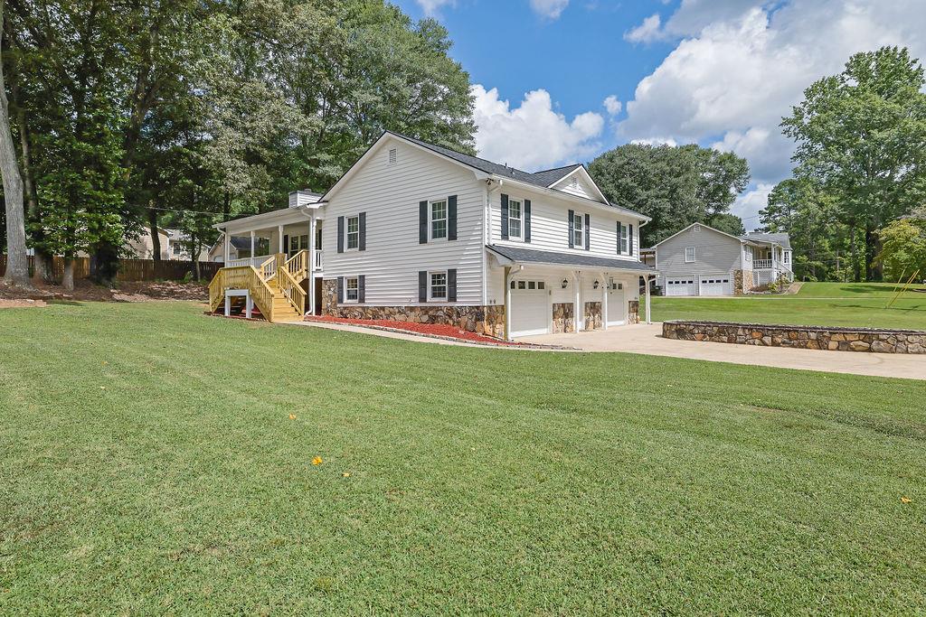 Updated 3 bed, 2 bath with additonal bonus room and office on a large, half-acre corner lot! If you’re looking for space in both the home and the yard, this home has it. As you walk through the front door you enter a beautiful living room where you are immediately greeted with a stone fireplace, cathedral ceilings with exposed beams and open views into an expansive kitchen. The kitchen has been updated and expanded to include a large island, new stainless steel appliances, a copper sink, beverage fridge, and a mini sunroom addition overlooking the private backyard. Oversized primary suite that can be accessed through the kitchen or the hall, which includes a windowed walk-in closet and large bath with a garden tub.
Downstairs you will find a finished office just off of the garage, as well as a very large bonus room that would be great as a media room and gym, or 4th bedroom!
Very spacious 2-car garage with the option to convert to a 3-car, and plenty of room to store all of the yard tools and hobby toys.
Interior has been freshly painted and new carpet installed in the secondary bedrooms and bonus room. New entry steps and freshly painted porch. New solar blinds are being installed on kitchen windows next week. Roof is 2 years old, and water heater is only 5 years old.
No HOA. Just 10 minutes to downtown Woodstock and easy access to the highway!