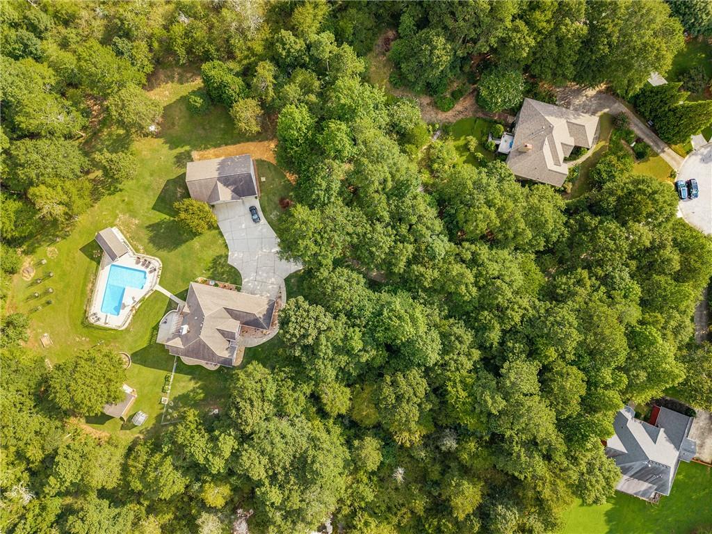 Private Ranch Retreat with Pool, Full Basement Apartment & 4.63 Acres
Experience luxury, comfort, and privacy in this custom 4-bedroom, 4.5-bath ranch with a full basement apartment—perfect for multigenerational living or guests. Nestled at the end of a cul-de-sac on 4.63 acres, this property blends modern upgrades with serene country charm.
Step inside to soaring ceilings, new hardwood floors, and fresh paint throughout the main level. All bedrooms on the main level have their own private ensuite bathrooms, offering comfort and privacy for everyone. The recently renovated kitchen is a chef’s dream, featuring leathered quartz counters, a spacious island, custom walk-in pantry, Kucht gas range, and Whirlpool appliances—all open to the inviting living room for effortless entertaining.
The primary suite boasts its own office space, while the lower level offers a complete apartment for extended family or rental income potential. Enjoy peace of mind with a new tankless water heater, whole-house filtration, UV water purification system, and video surveillance with property alerts.
Outdoor living is unmatched here—relax on the covered deck with pergola overlooking the fenced, L-shaped saltwater pool with a new liner and chlorinator. The pool house includes a half bath for convenience. Fruit trees, garden, new greenhouse, gardening shed and a creek add to the natural beauty, while a custom fire pit and horseshoe area make gatherings unforgettable.
Car enthusiasts and hobbyists will love the 2-car attached garage, plus a detached garage with a vehicle lift, workshop, and room for multiple cars. New 6" gutters, and a fenced front yard complete this incredible property.
Tucked away at the end of a long, winding driveway, this home offers the perfect blend of privacy, space, and modern comfort—just waiting for its next chapter.