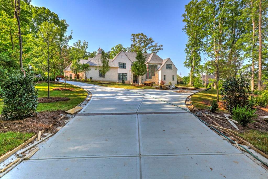 Sited on 2.4 private acres this fabulous new home designed by T.S. Adams. Open lvng floor plan with luxurious master suite on the main level with custom Carrera marble bath. Grand lvng rm w/fireplace, banquet sized dining rm, huge marble cstm ktchn with island+dining area and keeping room w/limestone fireplace that opens to vaulted outdoor living space. Iron doors lead to a level walk out bckyrd w/pool.4 gracious sized suites each with private bths on the upper level w/ study room.Built like a custom home a lot of other special features!Completion date August 2018!
