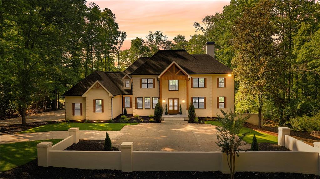 Welcome to this breathtaking four-sided brick estate, perfectly situated on a stunning lakefront lot with picturesque golf course views in one of Fayette County’s most prestigious gated golf communities, located within an award-winning school district.
This magnificent 7,500-square-foot home showcases an open-concept design with soaring 21-foot ceilings and panoramic views of the lake and golf course. The grand room is bathed in natural light, featuring a wall of windows and French doors that lead to a spacious deck, creating the perfect setting for relaxation and outdoor entertainment.
Designed for both comfort and functionality, this home features an executive office/library with a custom-built bookcase, offering a quiet and refined workspace. The expansive dining room provides an ideal setting for hosting formal dinners or family gatherings. The chef’s kitchen is a dream, boasting quartz countertops, a large island, soft-close cabinetry, a walk-in pantry, and a custom mud area.
The main-level master suite serves as a private retreat with his-and-her closets and a spa-like ensuite bathroom. Upstairs, two separate staircases lead to three generously sized bedrooms, including a secondary master suite with a luxurious ensuite bath, a large walk-in closet, and a second laundry room. The remaining two bedrooms feature ensuite baths with elegant floor-to-ceiling tile.
The fully finished basement offers an additional private in-law suite, complete with its own living area, full kitchen, and ensuite bath. This level also includes a wine cellar, a theater room, and an additional full guest bath, making it a true escape within the home.
Every detail of this estate has been thoughtfully updated, including new windows, a new roof, a fully upgraded deck with ceiling fans and recessed lighting, and all-new flooring throughout. Additional upgrades include a new electrical panel and wiring, new plumbing, updated lighting, exterior doors, custom built-ins, enhanced trim work, and a modernized laundry room with new appliances.
The exterior is just as impressive, featuring a meticulously landscaped yard and a spacious courtyard. Located in Fayette County’s premier gated golf community, residents enjoy exclusive amenities, including a clubhouse, pool, tennis and pickleball courts, a playground, and full-time security. The community also offers multiple lakes, over 100 miles of golf cart paths, and an optional 18-hole Arnold Palmer-designed golf course.
This is a rare opportunity to own a truly exceptional estate—schedule your private showing today!