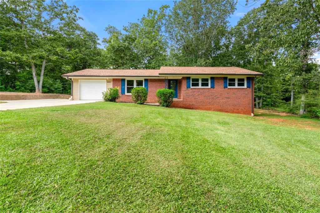 Welcome to 2921 Hill Circle, a stunning four-sided brick ranch that offers what today's buyers crave most: nearly an acre of prime land in the heart of Dacula, Georgia. This is a rare find that opens endless possibilities for small business operations, RV and boat storage, or simply the luxury of room to breathe that's becoming increasingly hard to find. This beautifully maintained home offers approximately 3,412 square feet of sophisticated living space, including four bedrooms, two full bathrooms, one half bath, and a bonus room-all designed with both comfort and functionality in mind. The main-level primary suite features a custom-organized walk-in closet, providing ease and elegance to everyday living while keeping everything conveniently on one floor. The heart of the home is the gourmet kitchen, which showcases stunning granite countertops, premium stainless steel appliances, and custom cabinetry with soft-close, pull-out drawers extending even into the pantry-a perfect blend of form and function. The open-concept design flows seamlessly into a warm, inviting family room with rich hardwood flooring throughout, while a thoughtfully designed laundry/mudroom adds exceptional utility with matching granite countertops and built-in storage solutions. The fully finished basement dramatically expands the home's versatility with an additional bedrooms, full bathroom, generous living area, and separate side entrance-ideal for multi-generational living, home office, guest accommodations, or potential rental income. The basement also features an Aquaguard Water Pump System for added peace of mind and protection. Positioned just 0.7 miles from the transformative Dacula City Core project-featuring a new municipal complex, open-air amphitheater, multifunctional greenspace, and central community hub set to complete in 2027-this location places you at the epicenter of Dacula's exciting future. In today's competitive market, you simply won't find another home offering nearly an acre of unrestricted land with no HOA restrictions under $400K. This is your opportunity to secure a property that delivers both immediate comfort and long-term value-where premium finishes meet practical luxury, and where space is never a compromise. Don't let this rare combination of location, land, and livability slip away.