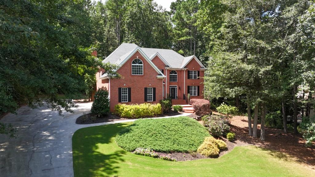 Welcome Home! Talk about VALUE in West Cobb! This 4-sided brick beauty sits in the highly sought-after Hill Rd area, tucked inside Stonegate -- a true executive community with estate-sized homesites. Step inside and you'll instantly notice the hardwoods, brand new carpeting and custom trim that make this home shine. The remodeled kitchen opens right into the two-story family room with fireplace -- the heart of the home. You'll LOVE the main-level office with a closet (hello, optional bedroom!). And let's not forget the laundry/mudroom right off the garage for real-life convenience. Upstairs you've got a stunning Owners retreat with Dual Sided Fireplace between the bedroom and sitting room! The Primary Bath is luxurious and ready for you to relax the days away! Three spacious secondary bedrooms, one with a private bath and the other two share a Jack & Jill bath. Need extra space? The terrace level checks all the boxes -- complete with a bedroom, full bath, and plenty of room for a teen suite, media room or the perfect in-law setup! Outside is your own private retreat -- a covered porch (that could easily go back to screened if you'd like!) overlooking a tree-lined backyard with firepit. Perfect for cozy nights or weekend gatherings. BONUS Features You'll Appreciate: Two newer HVAC systems with Nest thermostats, Newer architectural shingle roof, Oversized 3-car side-entry garage with epoxy floors, Central vacuum system Extended parking pad + championship basketball goal, Invisible pet fence. All in a top-rated school district, this home truly has it all -- space, upgrades, location, and community. Don't miss your chance to call 5327 Saville Drive HOME!