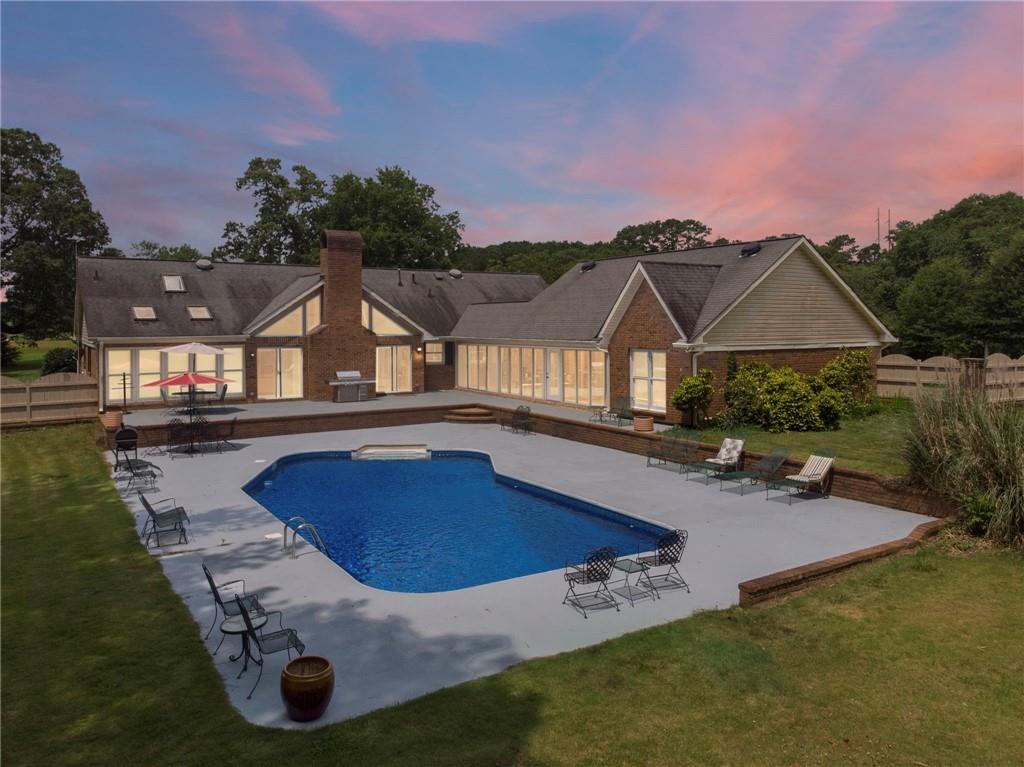 This private pool house near Atlanta is an ideal place to relax. This property sits on 3.5 acres of land and in one of the safest neighborhoods near Atlanta. Provided indoors on the property: karaoke, board games, video games and hot tub; pool table and table tennis (breezeway); outdoors: horseshoe set, swing, firepit, BBQ grill (gas and charcoal), cooler and swimming pool (only available May to September.) This 2700 sq ft ranch sleeps 10 with 5 queen beds, 5 TVs, and dining table seats 10. Property is 1.7 miles to downtown Fayetteville, 4 miles to the Pavilion, 4 miles to Trilith Studios, 10 miles to Fun Spot America and 25 miles to Hartsfield International Airport.