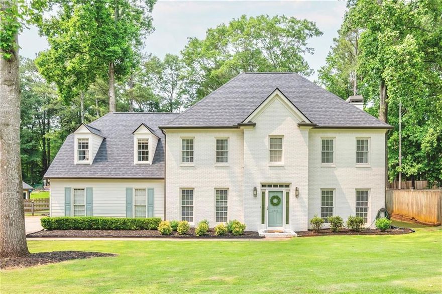 Stunning home located in the highly sought after Windsor Oaks Swim and Tennis Community in East Cobb with top rated, award winning schools!!! This timeless, classic brick home has been updated and has 4 bedrooms and 2 1/2 baths. Step inside to a two-story foyer and a floor plan filled with natural light and fresh neutral paint throughout. Large, flat lot with a fenced-in back yard is perfect for entertaining and leaves plenty of room to install that pool of your dreams. Open air patio is ideal for outdoor grilling. The beautiful kitchen features new quartz countertops and backsplash, cabinets, new flooring, stainless steel appliances, and breakfast bar overlooking the cozy, sun-filled family room with a wood burning brick fireplace and gas starter. Built in bookshelves flank each side of the fireplace. Enjoy the convenience of a second rear stairway from kitchen to upper level. Office on main boasts handcrafted trimmed feature wall and airy French doors. Spacious master suite with trey ceiling, large bath with voluminous ceilings, his and her vanities, separate large tub and walk in shower. Secondary bedrooms all feature handcrafted custom-trimmed walls. There is a finished staircase up to the attic for easy storage. Some of the upgrades are new roof, new plumbing, new piping throughout, brand new water heater, new exterior paint, multiple new windows. A long tree-lined driveway features plenty of parking for family and guests. Windsor Oaks amenities include 2 event pavilions, 4 brand-new tennis courts, a brand-new multi-purpose court for pickleball and basketball, pool, and playground. Don't miss out on this exceptional East Cobb home!