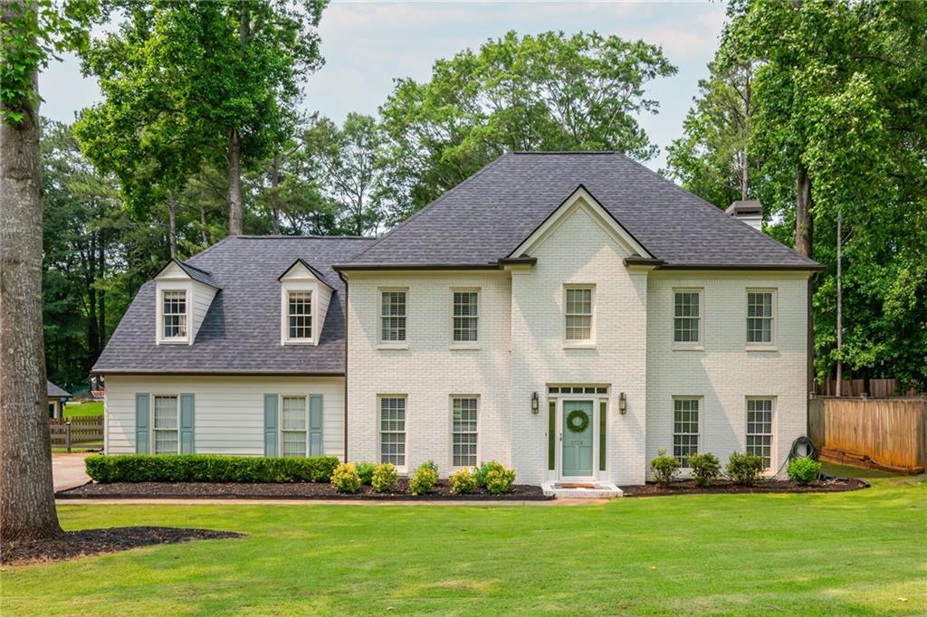 Stunning home located in the highly sought after Windsor Oaks Swim and Tennis Community in East Cobb with top rated, award winning schools!!! This timeless, classic brick home has been updated and has 4 bedrooms and 2 1/2 baths. Step inside to a two-story foyer and a floor plan filled with natural light and fresh neutral paint throughout. Large, flat lot with a fenced-in back yard is perfect for entertaining and leaves plenty of room to install that pool of your dreams. Open air patio is ideal for outdoor grilling. The beautiful kitchen features new quartz countertops and backsplash, cabinets, new flooring, stainless steel appliances, and breakfast bar overlooking the cozy, sun-filled family room with a wood burning brick fireplace and gas starter. Built in bookshelves flank each side of the fireplace. Enjoy the convenience of a second rear stairway from kitchen to upper level. Office on main boasts handcrafted trimmed feature wall and airy French doors. Spacious master suite with trey ceiling, large bath with voluminous ceilings, his and her vanities, separate large tub and walk in shower. Secondary bedrooms all feature handcrafted custom-trimmed walls. There is a finished staircase up to the attic for easy storage. Some of the upgrades are new roof, new plumbing, new piping throughout, brand new water heater, new exterior paint, multiple new windows. A long tree-lined driveway features plenty of parking for family and guests. Windsor Oaks amenities include 2 event pavilions, 4 brand-new tennis courts, a brand-new multi-purpose court for pickleball and basketball, pool, and playground. Don't miss out on this exceptional East Cobb home!