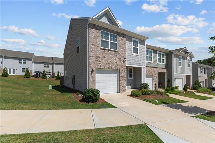 This newer end-unit townhome is available for immediate move-in. Step inside to a welcoming foyer that leads into a bright, open-concept living space. The kitchen features stainless steel appliances, including a refrigerator and built-in microwave, and flows seamlessly into the dining area and great room. A convenient half bath completes the main level. Upstairs, you'll find a spacious owner's suite with a private bath and a generous walk-in closet, two additional bedrooms, a full hall bath, and a laundry closet round out the second floor. Enjoy a small private patio out back-perfect for relaxing. Parking includes a one-car garage and driveway, with additional visitor spaces nearby. Landscaping is included. This townhome is ideally located just off GA HWY 316, offering easy access to Athens and Atlanta. You're only minutes from shopping and dining options, including Home Depot, Hobby Lobby, LongHorn Steakhouse, Publix, the new Kroger, Target, PetSmart, Kirkland's, AMC Movie Theater, Fort Yargo State Park, and so much more. A small dog under 20 lbs or a cat is welcome. Monthly pet rent will be determined through a third-party screening company. Washer and Dryer available by request.