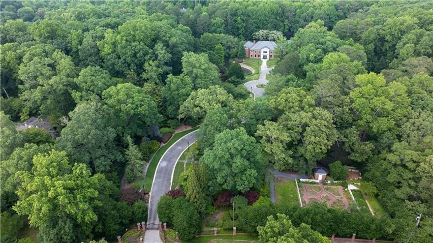 Amazing opportunity to own one of Atlanta's iconic estate properties on +/- 9 acres of manicured gardens, lake and par 3 golf hole. Recently TOTALLY RENOVATED, this property is spectacular! Fabulous primary suite with his and her baths and huge closets. Beautifully redone kitchen and family room with covered outdoor porch overlooking the pool and tennis court. Seller redid all the grounds and added a practice golf hole. There is also a log cabin on site which is a charming venue for entertaining. The 4 car garage can easily be expanded for the car collector. For the buyer who wants total privacy, this gated property provides an oasis within minutes of all the city has to offer. Truly a very special opportunity!!