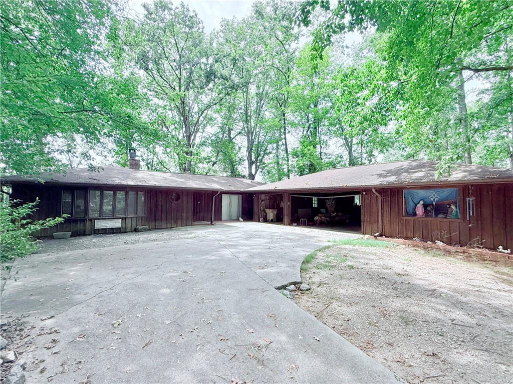 INVESTOR SPECIAL!!! SOLD AS-IS!! This 4 bedroom, 3 bathroom lakefront home is filled with character and potential. While it has not been maintained in some time and will require updates, it offers unique features throughout. The main level boasts a spacious great room with a double-sided fireplace opening to the living room, along with a wall of sliding glass doors across the back of the home, filling the space with natural light and lake views. The master suite is a true retreat with its own fireplace, skylights, private entrance to the back deck, and direct views of the water. A fully finished basement adds additional living space as well as an office and possibilities for customization. Step outside to enjoy the expansive lake views from the wrap around deck, or take advantage of your private single-slip dock with a party deck for boating and fishing. The property also includes a detached 3 car garage with an attached shop, providing ample space for storage, hobbies, or projects. With its prime lakefront location, generous layout, and distinctive features, this home presents a rare opportunity to renovate and create the ultimate lakefront retreat or investment property. With No HOA this property has endless possibilities for rentals and investment. The location is amazing, with plenty of restaurants, shopping, and even close to Northeast Georgia Medical Center. Don't miss your chance at this rare chance to own and design your dream home.