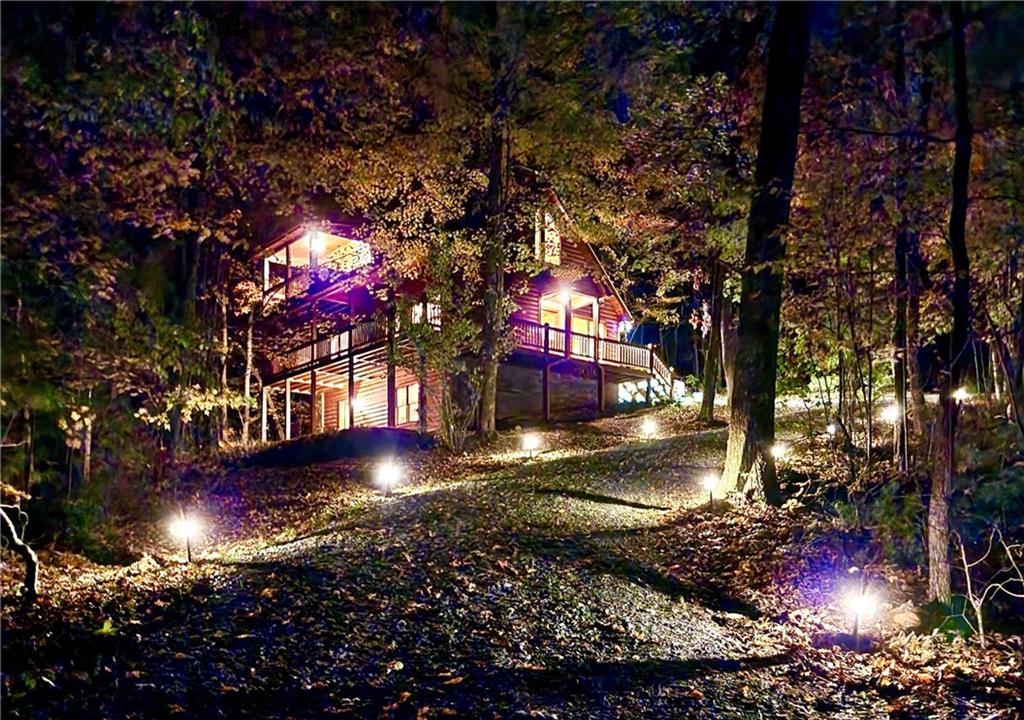 Appointment only! This gem, fondly named "Ruby,” has a gated entrance, a lovely private driveway approach and a stunning evening appeal! Perfectly located, minutes to Mercier Orchards, Bear Claw Vineyards & Winery, and a 10 minute straight shot to the city of Blue Ridge. This “One Owner Home” is pristine inside and out with recent exterior staining and in excellent condition due to continuous spot-on maintenance and gentle use. “Ruby" is the perfect lock and go second home with a 90-minute travel time or less in non-peak traffic from Roswell, Alpharetta, Marietta, Sandy Springs, Chattanooga TN and more! It has a comfortable open floor plan with a separate Dining Room and a vaulted Great Room with a floor to ceiling wood burning Fireplace. Step out to relax or grill dinner on the full length, fully covered Rear Deck with beautiful mountain views to the North and West. The vaulted Owners Suite opens to its own Covered Porch with a peaceful long-range view. The generously sized En Suite Bathroom has a spa tub, separate shower and large walk-in closet with great storage and shelving. There is a cute Office/Zoom Nook on the 2nd level. The main level Guest Bedroom has French Doors to the Covered Deck. The Guest Bathroom can be entered from the bedroom or hallway and has a Tub/Shower Combo. There is a Laundry Room with a full-size washer and dryer plus added storage above. The full Unfinished Basement is stubbed for a bathroom with perfect potential for additional finished space to complete "your way!" It has both an inside and outside entrance with access to a walk-out patio. The Ring Security System includes Sensors on all doors, Motion Detectors and Smoke/Co2 detectors. The parking area can accommodate 4 vehicles. Two newer homes in the Million Plus range are two doors away in both directions. If you are looking for a mountain home with Super Easy Access from the main road, this is it! No curvy, winding, or super steep roads to challenge and no “thru-road traffic.” You are at the end of a privately owned road. All appliances to remain. Modest monthly utilities with Tri State Electric, water supplied by Appalachian Water and internet service with ETC. Owner is the Listing Agent and a Licensed Real Estate Broker in the State of Georgia. APPOINTMENT ONLY! LOCKED ENTRANCE GATE AND SECURITY SYSTEM.