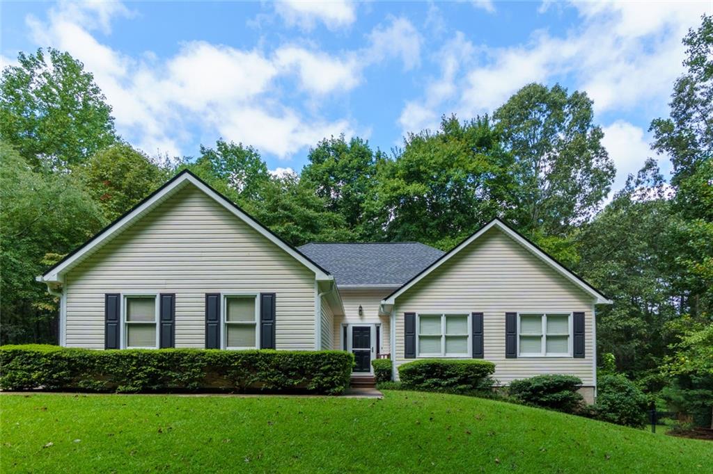 Discover the perfect blend of space, privacy, and potential in beautiful Canton, GA. This charming 3-bedroom, 2-bath ranch home sits on 2.28 private acres, offering peaceful surroundings and room to grow. With 1,507 sq ft on the main level and an additional 1,507 sq ft unfinished basement, you’ll have endless opportunities to expand and customize. Built in 1998, the home features an inviting layout designed for easy, single-level living. The home is filled with natural light with a bright, airy living room, vaulted ceilings, and a cozy fireplace. The kitchen is spacious with a breakfast area, all flowing seamlessly into the dining area—perfect for family meals or entertaining guests. The main-level primary suite includes a walk-in closet and en-suite bath with separate shower and a soaking tub. Two additional bedrooms are well-sized and share a full hall bath. A full, unfinished basement offers endless potential—whether you're looking to create a home gym, workshop, additional living space, or in-law suite (it’s stubbed for a bathroom!). With exterior access, it’s also ideal for storage or future expansion. Step outside and enjoy the peace and privacy of your own acreage. If you're gardening, playing, or relaxing on the back deck, there's plenty of room to enjoy the outdoors. All of this while being just minutes from shopping, dining, schools, healthcare, and major commuter routes! Whether you’re looking for move-in ready comfort or a property to personalize, this home delivers unmatched potential in a desirable Canton location.