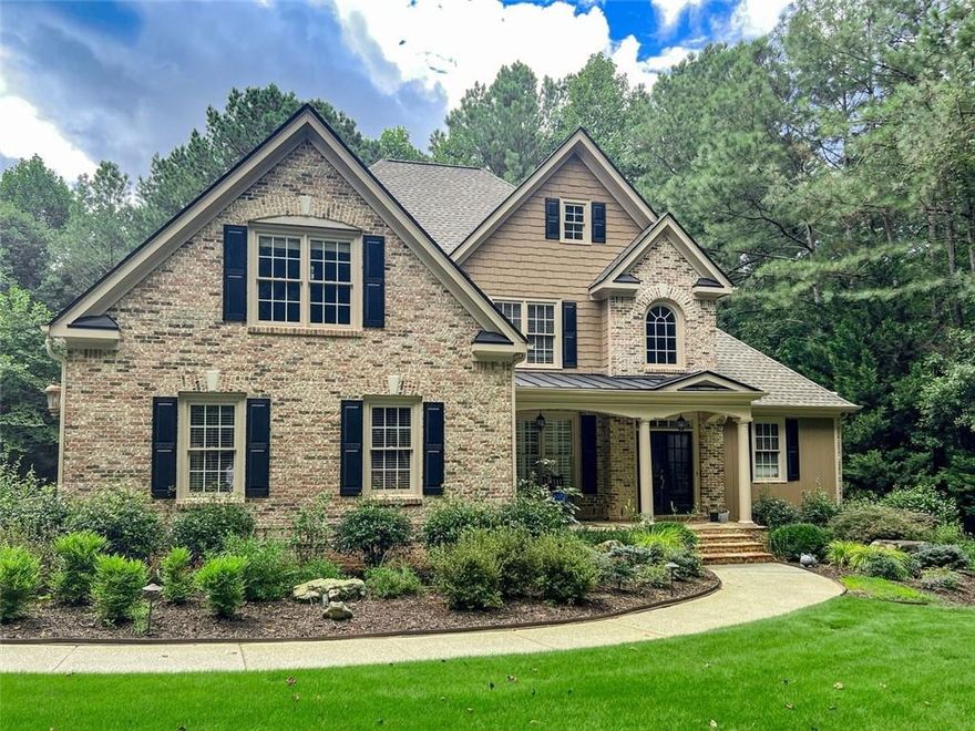 Exquisite Brick Estate on Over 2 Private Acres in Alpharetta

Welcome home to this stunning four-sided brick estate located in a private, upscale enclave of Alpharetta, within desirable Cherokee County and top rated schools. Nestled on a sprawling 2+ acre lot, this property offers exceptional privacy and tranquility, just minutes from Milton and top shopping and dining destinations and Top-rated schools!
As you enter through the covered front porch, you’re greeted by a grand two-story foyer with detailed moldings and rich hardwood flooring. The elegant floor plan flows seamlessly into a formal dining room and a fireside family room—perfect for entertaining.
The main level features a spacious primary suite with large windows overlooking the wooded backyard, offering a peaceful retreat. The en-suite bath includes a soaking tub, separate shower, and generous closet space. The well-appointed kitchen features a breakfast nook, ample cabinet storage, and views into the family room. A large laundry room on the main level offers potential for conversion to a bedroom with full bath.
Upstairs, you’ll find three additional bedrooms and a bonus room ideal for a media room, playroom, or office.
The finished terrace level is designed for entertaining and relaxation, offering space for a full guest suite, den with fireplace, game room, and pre-plumbed connections for a future kitchen and bar.
The expansive backyard is level and ready for a pool, outdoor kitchen, or other custom features to create your own private oasis.
This home offers the perfect blend of luxury, space, and location—set in a quiet, estate-sized community with easy access to major amenities.