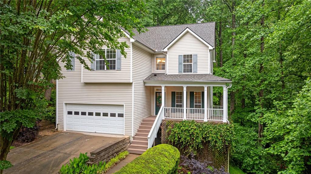 Welcome to this beautifully maintained 3-bedroom, 3.5-bath home tucked away on nearly 1 ACRE of a PRIVATE, WOODED LOT. Enjoy peace of mind with a 1-year-old roof, brand-new septic system, and recently installed carpet throughout. Step inside to an inviting OPEN-CONCEPT design highlighted by a soaring two-story family room, perfect for both everyday living and entertaining. The updated kitchen features QUARTZ countertops, SUBWAY TILE backsplash, STAINLESS STEEL appliances, and white cabinetry. All of this is overlooking the serene backyard with direct access to the spacious deck. Upstairs, the primary suite feels like a retreat, complete with a spa-inspired bath featuring a CUSTOM FRAMELESS SHOWER, large soaking tub, dual sinks, and a generous walk-in closet. Two additional bedrooms and a full bath complete the upper level. The PARTIALLY FINISHED BASEMENT with a FULL BATH provides flexible living space for a media room, home office, gym, or guest suite, while still providing ample unfinished storage space. Enjoy walk-out access from the basement to the FENCED BACKYARD. This home blends comfort, modern updates, and functionality. It is truly ready for you to move right in! This must-see home is also within walking distance to top-rated LAMBERT HIGH SCHOOL and just minutes from parks, shopping, restaurants, and GA 400! Schedule your private tour today.