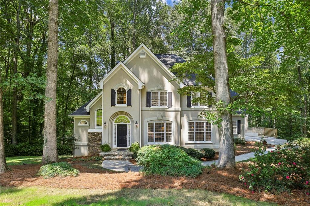 Welcome to your private 1.2-acre retreat in Milton! Located in the sought-after Cambridge High School district, this home is tucked away on a peaceful cul-de-sac, offering both privacy and convenience—just minutes from GA-400 and the premier shopping, dining, and entertainment at Halcyon and Avalon.
Step inside to a sunlit two-story foyer and gleaming hardwood floors. A vaulted fireside living room frames panoramic views of the surrounding greenery. The kitchen features granite countertops, stainless steel appliances, a gas cooktop, and generous storage. A main-floor bedroom with a recently renovated full bathroom is perfect for guests.
Upstairs, the primary suite boasts a walk-in closet and an expansive bathroom with a soaking tub, double vanity, and separate tile shower. Two additional bedrooms share a Jack-and-Jill bath.
The freshly painted terrace level includes an additional bedroom, a full bathroom, and plenty of storage. Extending the length of the home, the spacious wooden deck is the ideal setting for grilling, dining, or simply unwinding. The large lot provides room for pets, gardening, and play. This Milton retreat combines privacy, convenience, and comfort—and is ready for you to call home.