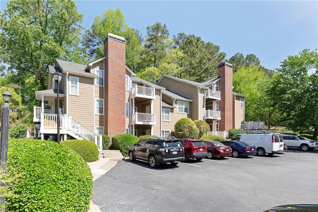 Tucked away in East Cobb’s desirable location, this 2-bedroom, 2-bath condo offers easy, everyday comfort in the sought-after Walton High School district. Surrounded by wooded views and just minutes from parks, shopping, dining, and top-rated schools, it’s the perfect blend of convenience and serenity.
Inside, the open layout features a sun-filled family room with a cozy fireplace, a dining area, and a kitchen with plenty of cabinet space. The owner's suite includes a large walk-in closet and a private bath, while the secondary bedroom offers flexibility for guests, a home office, or quiet downtime. Step outside to a private, covered patio ideal for morning coffee or evening wind-downs. The community includes a pool and direct access to the Cochran Shoals loop and Sope Creek trails. HOA dues cover water, trash, exterior maintenance, pest control, landscaping, hazard insurance, and more—allowing you to focus on enjoying your surroundings. With a comfortable layout and an unbeatable East Cobb location, this condo presents a fantastic opportunity in one of the area’s most established communities.