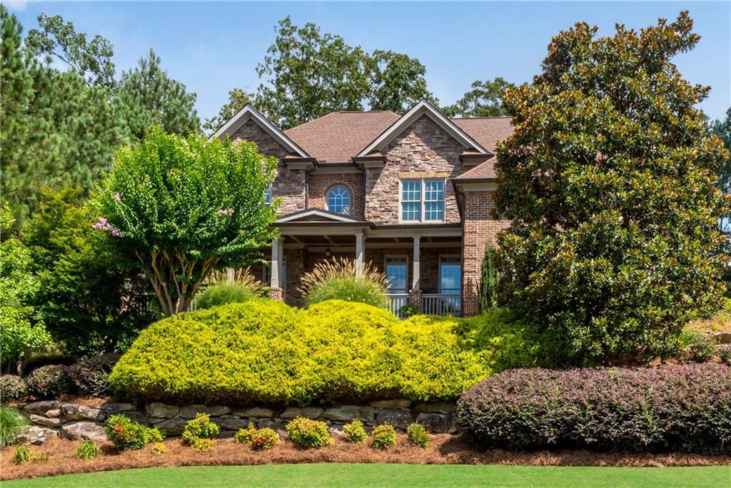 3-Sided Brick & Stone Executive home w/HUGE level fenced backyard! Built by one of the original Riversprings CUSTOM home builders from Vintage Communities Builder Group. True wrap around rocking chair front porch w/double doors to the dramatic two-story foyer featuring inlay design site-finished hardwood floors extending to the formal dining, kitchen and main level hallways. French doors to the main level study with intricate beadboard coffered ceiling. Formal dining w/extensive trim package and bump out for buffet or China cabinet. The soaring two-story great room features a stacked stone fireplace and built-in bookcases. Spacious island w/quality cabinets featuring a cabinet vent hood, walk-in pantry, gas cooking, below counter microwave and double ovens. Brick herringbone tile laundry/mud room w/cabinets, laundry sink and door to driveway. Hard to find main level guest bedroom plan that features a private full bath for bedroom + separate half bath for main living areas. You will feel like you are at the Four Seasons in this premium oversized primary suite featuring a tray ceiling, sitting room w/gas fireplace, spa bath w/jetted tub and separate double tile shower plus a massive custome closet! One upstairs bedroom w/private bath and other two share a jack & jill bath. Finished terrace level features a rec room, additional exercise room or office and a full tile bath. Several additional unfinished rooms for additional expansion. Relax outside on the covered porch w/stacked stone gas fireplace stepping down to the additional deck with plenty of room for dining area and grilling. Walk to the impressive amenity package including clubhouse, 4 tennis courts, soccer field, basketball, pool w/slide and playground! Great location w/easy access to HWY 316 and shopping at corner of 316 and HWY 316 featuring Target, Publix, HomeGoods, Belk, Michaels, Chick-Fil-A, Starbucks, LongHorn Steakhouse, AMC Theater and more!
