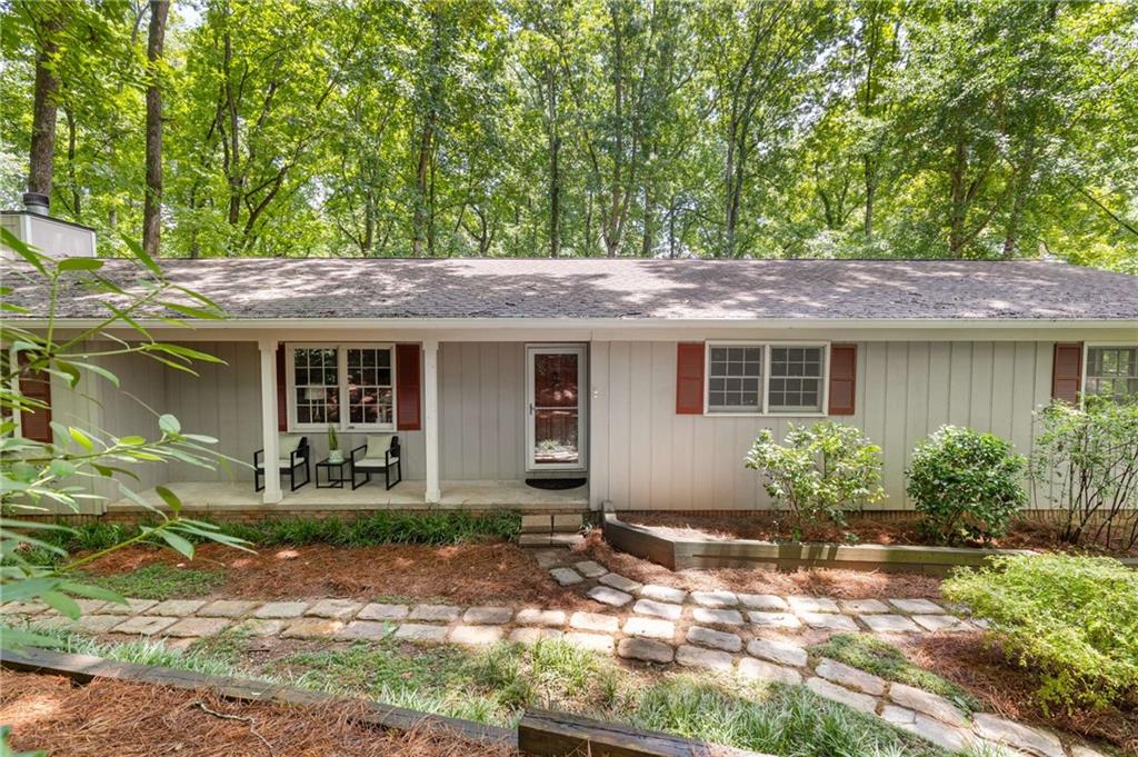 Tucked away on a quiet cul-de-sac in East Cobb, this beautifully updated ranch sits on a private, ¾-acre lot that offers a rare combination of lush natural surroundings & open, usable space. From the moment you arrive, you’ll notice how the mature front landscaping creates a natural buffer from the street, offering a sense of calm and privacy. Step into the massive, level backyard—a grassy, park-like setting surrounded by woods on all sides. It’s the kind of outdoor space that feels like your own secluded retreat, perfect for relaxing, entertaining, or letting kids and pets roam freely.
Inside, you'll find newly refinished REAL hardwood floors throughout the entire home and a spacious layout perfect for both daily living and hosting guests. The welcoming foyer opens to a private library or den, ideal for a home office or cozy reading space. The vaulted great room is truly impressive—huge and filled with natural light, it features a fireplace and French doors that open to the expansive back deck.
The great room flows seamlessly into the updated kitchen, which boasts a massive island perfect for gathering, abundant cabinetry and counter space, newer stainless appliances, and even a wine fridge. A wall of built-in cabinets offers extra storage or a serving area.
The home offers three bedrooms on the main level, including a spacious primary suite with two closets. Step outside to a large deck that overlooks the private backyard oasis—where it’s so peaceful, you’d never know you had neighbors.
A full unfinished basement provides tons of storage or potential for future living space. Located in a top-rated school district and just minutes from I-75, this home delivers the best of both worlds: convenience and total privacy.