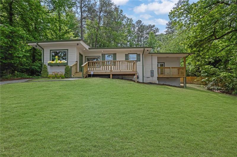 Step into a home that blends modern comfort with timeless charm—fully remodeled and move-in ready! This beautifully updated 3-bedroom, 2-bath residence welcomes you with a bright, open floor plan, fresh paint inside and out, and stylish finishes throughout. The heart of the home is the stunning kitchen, featuring white shaker cabinets, granite countertops, stainless steel appliances, and elegant fixtures that make everyday living a delight. The updates continue in both bathrooms, where you’ll find new vanities, custom tile work, and thoughtful touches designed for comfort and convenience. The spacious master suite is a true retreat with soaring ceilings, a large walk-in closet, and a luxurious en-suite bathroom complete with a double vanity and a beautifully tiled shower. Step outside onto your private deck or front balcony—both offering peaceful views of mature trees and a serene landscape. A unique bonus is the hall bathroom’s dual-purpose design, doubling as a laundry room with storage cabinets and a travertine-tiled tub/shower combo—perfect for maximizing space and functionality. But the charm doesn’t stop at the front door. Outside, the property shines with a large, private lot that includes a sloping front yard and a partially fenced backyard—ideal for entertaining, gardening, pets, or playtime with the kids. And here’s where this property really stands out: a massive 750+ sq. ft. detached garage offers incredible versatility. Whether you need a workshop, studio, space for your business, vehicle storage, or your next creative project, this garage delivers endless possibilities. It’s a dream come true for artists, woodworkers, small business owners, car enthusiasts, and entrepreneurs alike. Located just minutes from I-20, Six Flags, downtown Atlanta, shopping, dining, and top-rated schools, this home combines the peace of a secluded setting with unbeatable convenience. Investor-owned with no seller’s disclosure, no HOA, and a 1-year home warranty from American Home Shield included. If you’re looking for a home that works as hard as you do—with style, space, and serious potential—schedule your private tour today and see what makes this property truly one of a kind!