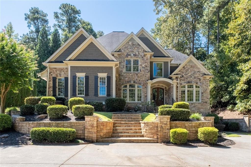 Tucked away at the end of a private, tree-lined drive in one of the area’s most exclusive communities, this custom-built lakefront estate offers an extraordinary blend of luxury, seclusion, and breathtaking beauty. Set on over an acre of professionally landscaped grounds, the home features six spacious bedrooms and six elegant bathrooms, with an open-concept design that floods the interior with natural light and showcases upscale finishes throughout. The gourmet chef’s kitchen, complete with premium appliances and bespoke cabinetry, flows seamlessly into a gracious keeping room and sunlit breakfast area. The main-level primary suite is a private sanctuary with its own fireplace, spa-inspired bath, custom walk-in closet, and direct access to a covered porch overlooking serene lake views. A fully finished daylight basement includes a private home theater and expansive living space, all freshly painted and designed to capture the tranquil surroundings. Outdoors, enjoy an extended stone patio, mature trees, and a lush backyard that opens to the water—perfect for entertaining or peaceful reflection. Impeccably maintained and move-in ready, this one-of-a-kind retreat offers timeless craftsmanship, modern comfort, and a resort-like lifestyle near top-rated Roswell and Cobb County schools, fine dining, and commuter routes.