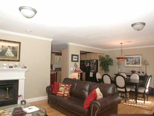 MUST SEE THIS BEAUTIFUL END UNIT IN PRIVATE, GATED COMMUNITY JUST MINUTES TO 400!! LOVED BY THE ORIGINAL OWNER W/ UPDATED FEATURES: HARDWDS, OPEN KITCHEN VIEWS DINING & GREAT RM, PLAN.SHUTTERS, WOOD BLINDS, PRIVATE PATIO & YARD, 2 CAR GRGE W/STORAGE. ITS A GEM! SWIM/TENNIS/CLUBHSE.