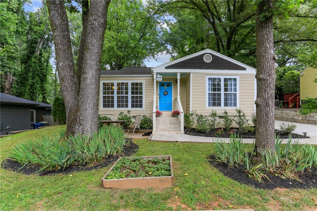 Welcome home to your very own quintessential East Atlanta bungalow, situated on a large, beautifully landscaped lot on a quiet street, a short walk from both East Atlanta Village and Burgess-Peterson Academy! The charming front porch welcomes you into your open floorplan living space with a large, open kitchen and spacious living/dining area. Hardwood floors guide you down the hall past two full-sized bedrooms and a full hall bathroom to your oversized primary suite with more space than you could ever need. The massive primary suite features a walk-in closet and en suite bath with double vanity and separate bathtub and shower. As you exit your living space, you're greeted by a deck perfect for upcoming summer nights before entering your enormous backyard with endless possibilities, including a large storage shed. If you're looking for intown living in East Atlanta with great walkability, space, and a large lot, 404 McWilliams Ave. has you covered!