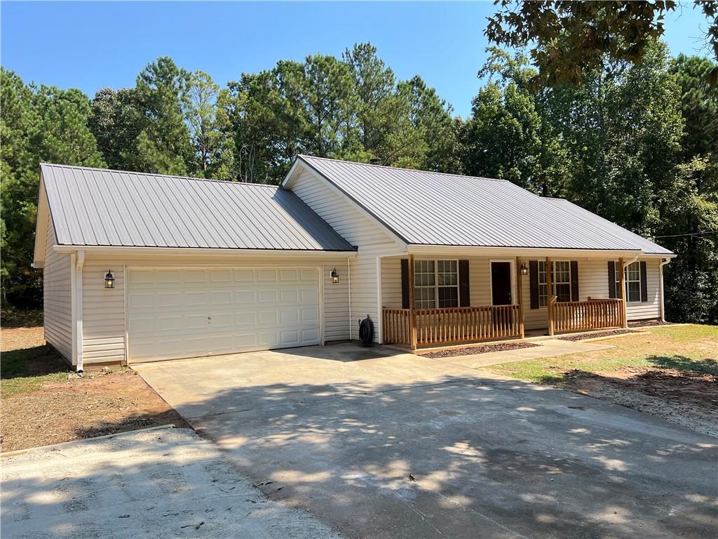 Updated 3BR/2BA Ranch on 1 Acre in Quiet Covington Cul-de-Sac! Move-in ready with renovated all-electric kitchen, new cabinets, and stainless steel appliances. Fresh paint and LVP flooring throughout—no carpet! Spacious living room with high ceilings and fireplace. Master suite with separate tub/shower. Expanded driveway for extra parking, plus 2-car garage with storage shelves. Septic recently serviced/pumped. Peaceful, no-HOA neighborhood. Don’t miss this one! FHA financing will be accepted after the 90 day seasoning period is over on 9/29. Fridge or washer/dryer combo with full priced offer closing within 30 days!