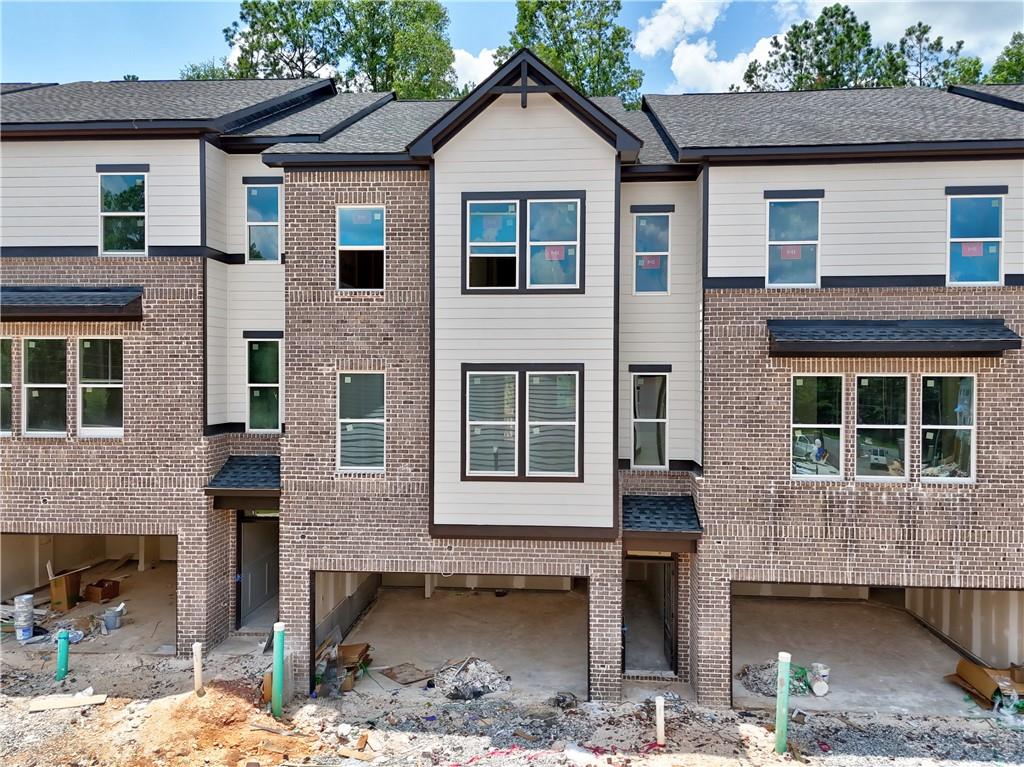 Richardson Housing Group – the Kinsley floor plan, a 5-bedroom design with a private covered back deck in the gated community of Parkstone Row in Tucker, GA. This exclusive 33-home neighborhood is ideally located just 12 miles northeast of Atlanta and offers quick access to I-85, I-285, and Highway 78, placing shopping, dining, parks, and local events all within convenient reach. Parkstone Row is also located in the highly regarded Parkview High School District, making it a top choice for buyers seeking quality schools and convenience. The homes in Parkstone Row feature a premium list of modern finishes that outshine the competition. Brick exteriors with cedar accents, 3/4 view front doors, and 30-year architectural-style shingle roofs create curb appeal and long-lasting value. Inside, you'll find designer kitchens with quartz countertops, shaker-style cabinetry, stainless steel appliances, subway tile backsplash, and pendant lighting over the island. High-end details continue throughout with 1x6 baseboard trim, 1x4 door casings, 1x4 window surrounds, 5-panel interior doors, flat-panel wainscoting in the foyer and dining area, black hardware and fixtures, oak site-finished stained hardwood stairs, and fully tiled master showers on the floor and walls with frameless glass doors. LVP flooring extends through the main level and continues upstairs in the common areas, providing both durability and style where it’s often overlooked. Both levels feature 9-foot ceilings, and the main level is enhanced by 6-foot-tall windows that fill the space with natural light. Each home also includes an electric vehicle charging outlet. HOA dues cover lawn maintenance, termite bond, and select exterior building maintenance, offering a low-maintenance lifestyle in a secure, gated setting. This home is under construction; photos of a finished home are not available for this floor plan. The photos shown are of the actual home currently listed for sale and will be updated as construction advances. Ask about up to $10,000 in closing cost incentives when using an approved lender, plus options for 100% financing or a 1% below-market interest rate.