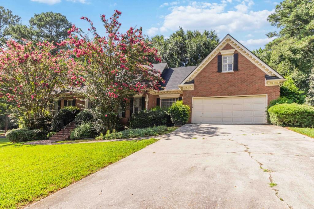 Spacious 4BR/2.5BA Home with lots of room in Stone Mountain! Don't miss this opportunity to own a well-built 4-bedroom, 2.5-bath home ideally situated in Stone Mountain, just 4.9 miles from the renowned Stone Mountain Park. This property offers great bones and functional features ready for your personal touch. Inside, enjoy the warmth of hardwood floors on the main level, a bright kitchen with white cabinetry, and a primary suite conveniently located on the main floor. You'll find a rare boat garage converted to an exercise area. Convert back to storage. Easy Access to Stone Mountain Freeway Close to Shopping, Dining & Entertainment. With a solid structure and a highly desirable location, bring your vision and handyman skills to make this home shine again.