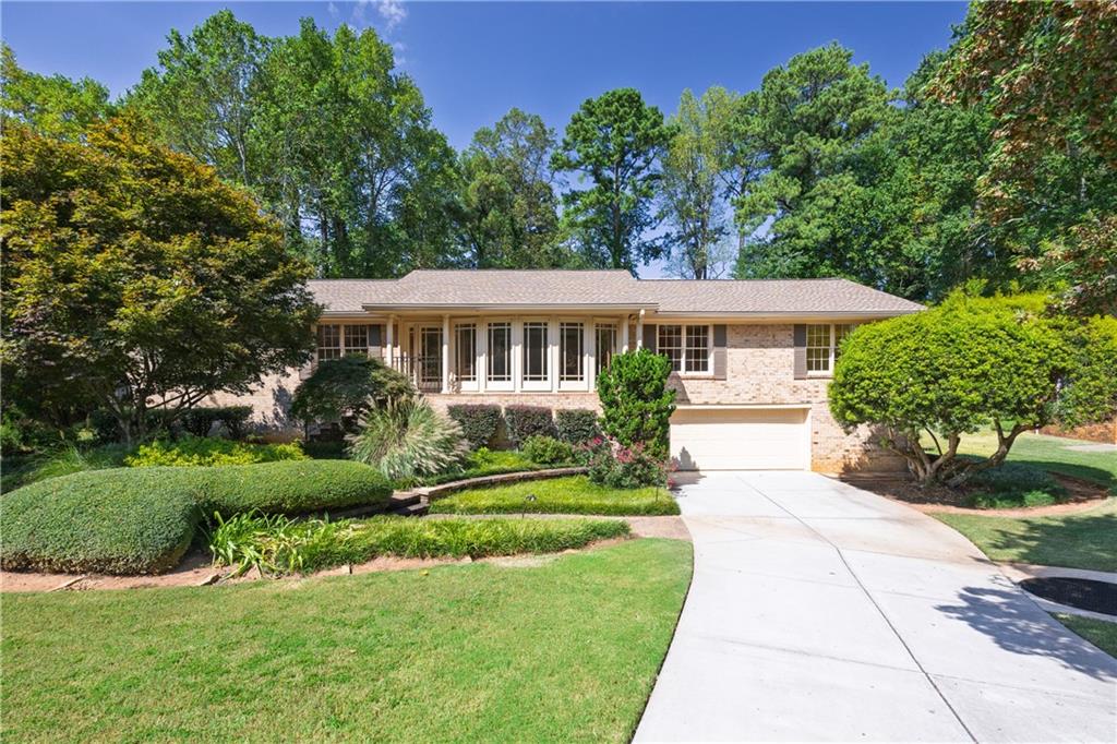 Welcome to 1415 Mosswood Lane SE, a charming brick ranch in one of Smyrna’s most desirable, low-turnover neighborhoods. This four-bedroom, two-bath home sits on a full basement and offers the perfect blend of timeless character, modern convenience, and outdoor living.
From the moment you arrive, you’ll notice the pride of ownership throughout the community—no HOA, yet every home is beautifully maintained. This property stands out with its manicured landscaping, lush lawn, and a backyard oasis designed for entertaining. A sparkling pool is the centerpiece, surrounded by greenery and thoughtful outdoor spaces that invite relaxation year-round.
Inside, the single-level ranch layout offers comfort and functionality. The spacious living areas are warm and welcoming, with natural light flowing through. The four bedrooms provide flexibility for family, guests, or a dedicated home office. The full basement expands your options even further—whether you envision a media room, gym, workshop, or extra storage, there’s space to make it your own.
Located just minutes from Smyrna Market Village, The Battery/Truist Park, and major highways, this home combines suburban tranquility with unbeatable convenience. With very little turnover in this neighborhood, opportunities like this are rare—don’t miss your chance to call this beautifully maintained property your own.