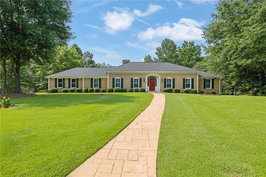 A premier offering in this 4-sided brick ranch nestled on a beautifully landscaped 1.3-acre corner lot in the heart of East Cobb. With over 5,300 square feet of refined living space, this residence exudes traditional elegance and modern comfort. From the moment you step into the gracious foyer, you’ll notice the real hardwood floors, sophisticated living and dining rooms, plantation shutters, and a floorplan designed for everyday luxury and effortless entertaining. The chef’s dream kitchen is a showstopper—featuring an expansive center island, granite countertops, stainless steel appliances, custom cabinetry, a Butler’s pantry, built-in wine rack, and wine cooler. Just off the kitchen, a sun-drenched glass-enclosed sunroom provides the perfect destination for morning coffee or afternoon reading. The main-level primary suite is a serene retreat, offering dual closets and a spa-inspired en suite bath with a luxurious walk-in shower. The finished terrace level is a home unto itself—complete with a living room, full spirit bar, billiard room, game room, home office, a renovated full bathroom, private bedroom, dedicated spa room, and a fully equipped home theater with all AV equipment and seating included. Step outside to a backyard oasis. The expanded deck overlooks a lush, park-like setting featuring a sparkling gunite inground pool, a 15’ x 12’ greenhouse, matching shed, and a charming playset. Located in one of East Cobb’s most sought-after school districts with convenient access to top-tier shopping, dining, and entertainment, this timeless estate offers the best of space, privacy, and sophistication.