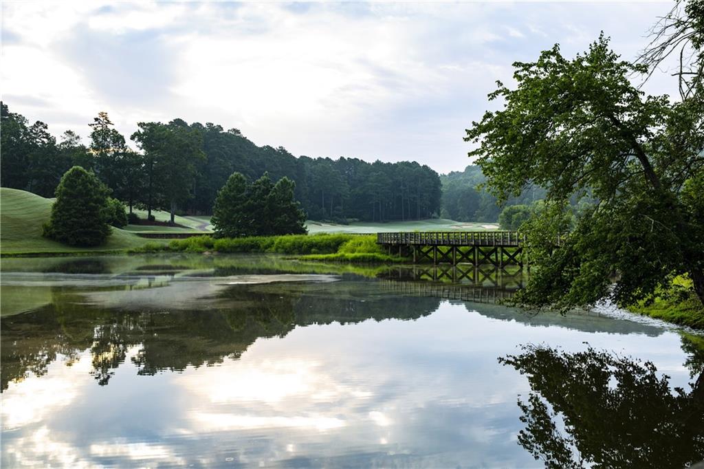 At 5.35 +/- acres, you can build just about any home. This lots sits way up high and levels out to a beautiful building spot with a babbling creek and waterfalls. If privacy is what you are looking for then look no further. The minimum sf is 3500 above grade. This lot will be a great lot for a slab, walk out backyard with side daylight basement or walk out basement. You choose! Top Rated Bob Cupp Golf Course, gated with guard, multi million dollar club house and swim tennis. Call for a personal tour.
