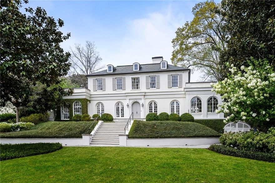 Perched above Peachtree Battle on one of Haynes Manor’s original lots, this fully renovated 1920 Georgian estate seamlessly blends historic charm with refined modern living. With architecture by Stan Dixon, John Howard, and Norman Askins—and renovations by Mike Hammersmith—every detail has been thoughtfully reimagined across 7,500+ of fully conditioned living space. Beyond the steel windows and slate roof, enter a grand receiving room with 10-foot ceilings, French oak floors, and original plaster moldings. The marble-clad chef’s kitchen flows to a covered porch with electric screens, ceiling heaters, and a recessed 65-inch TV—overlooking a walk-out pool featured in Serena & Lily’s 2023 catalog. Surrounded by evergreen turf, espalier pear trees, and a firepit, this backyard was made for entertaining. Inside, enjoy a natural wine cellar, smart lighting, security, and abundant storage. Five patios, two sunrooms, and a mahogany study offer multiple spaces to unwind, while a safe room, mudrooms, and a four-car garage add peace of mind and practicality. A true entertainer’s paradise, this home captures the best of old and new in one of Atlanta’s most prestigious neighborhoods.