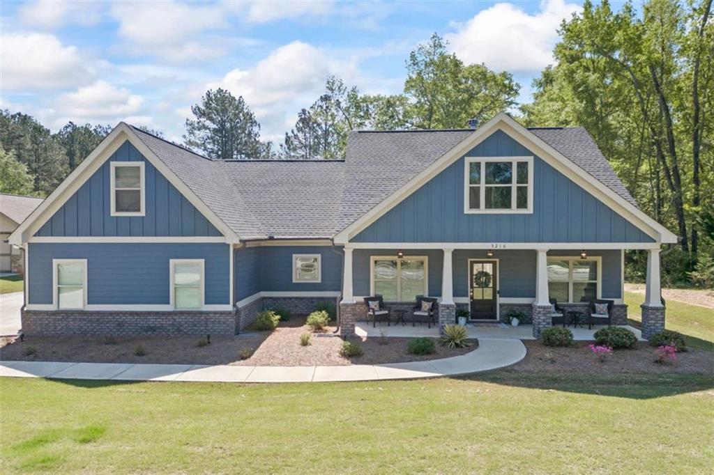 4/3 Ranch with Teen Suite Up with Huge Walk-In Closet. Screened In Rear Porch with Outdoor Fireplace! Directly Located between Loganville and Monroe. Close to Area Amenities. Highway 78, Community Park & Splash Pad Nearby. Discover timeless charm and modern comfort in this beautifully designed Craftsman-style home. Featuring an open-concept layout with the primary suite on the main level, this 4-bedroom, 3-bathroom home offers both convenience and style in every detail. The spacious master suite is a serene retreat, complete with an elegant spa-like bathroom. A smart split-bedroom floor plan ensures privacy, while the upstairs bonus area can double as a teen suite and also provides a quiet flex space, perfect for a home office or study, gym, or movie room. The heart of the home is the stunning family room with reclaimed mantle, floating shelves and cabinets. The family room flows seamlessly into the gourmet kitchen. Enjoy cooking and gathering with built-in wall oven and microwave, granite island, cooktop, and a cozy breakfast bar. Step outside to your own outdoor sanctuary with an inviting screened-in covered patio with its own fireplace, overlooking a professionally landscaped backyard. An irrigation system keeps everything lush and green, making outdoor living easy and enjoyable. Comfort, style, and functionality come together beautifully in this Craftsman gem. Welcome home!