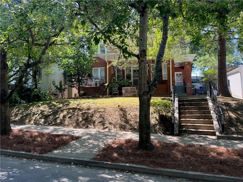 Nestled in the heart of Virginia Highland, this 1 BR-1BA unit is on the main level of this updated 1925 Brick Quadraplex. Right around the corner from Piedmont Park, Ponce City Market, the Beltline and an abundance of bars, restaurant's and coffee houses.Inside features high ceilings, hardwood floors. neutral paint colors, classic base and crown molding and loads of charm. Open Living room, built in bookcases, right side area for small table or chairs or "home office". Plenty of light through the windows. Small galley kitchen, black and stainless refrigerator, and stove, double sink and white cabinets and hardwood floors. There is a decent size pantry/closet opposite the frig. The bedroom has small closet, wood floors, double windows and door that leads to the laundry/storage room, stackable one piece washer and dryer and access to the back and the parking area. Full bathroom with classic black/white tile floor's, tub/shower combo and natural light through the windows. There is a basement shared with other tenants to store items in, you have a door with access to it from your unit. One parking space in back for tenant, ( unassigned) and guest park on the street. Tenants pay for gas, power, water and cable. Owner has specific criteria to meet which is min credit score of 685+, 2.5 verifiable income, great rental history, NO PETS, No Smokers. one year lease. Sorry this is not in the Housing Voucher Program.