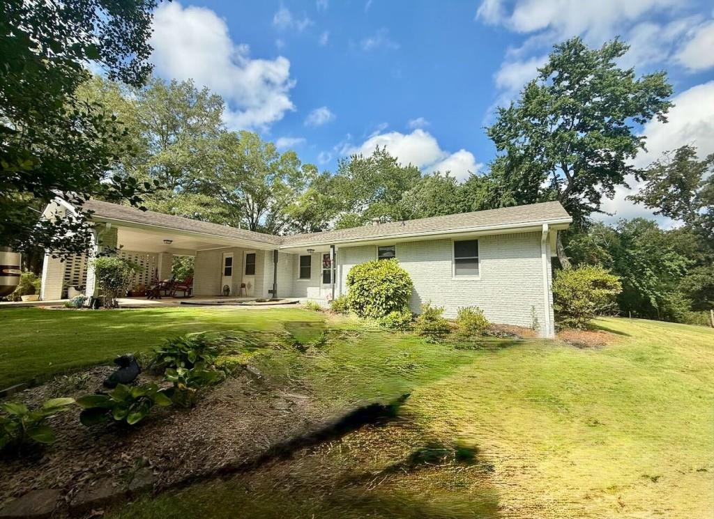 Welcome to this spacious 3-bedroom, 2-full bathroom home situated between the highly sought-after Villa Rica community, conveniently located near I-20 and downtown Carrollton. This private property sits on a generous 2-acre lot and offers the perfect blend of space, functionality, and outdoor enjoyment. Step into a welcoming open floor plan that includes a formal living room, dining room, and kitchen, ideal for hosting gatherings. The open-concept family room features a cozy fireplace and flows seamlessly into the kitchen, which boasts new LVP flooring, stainless steel appliances, and a gas cooktop, making it the heart of the home. This ranch-style home offers a main-level primary suite connected to an updated bathroom featuring granite countertops, updated cabinetry, a walk-in tiled shower, and new flooring. Two additional bedrooms share a well-appointed full bath. Fresh paint throughout the home adds a bright, updated feel. The main-level laundry room, conveniently located near the kitchen, enhances everyday living. Enjoy the outdoors with a large back deck and a covered front patio. Additional features include extra driveway space for guest parking and a storage shed for tools and gear. Also located on the property are two additional storage sheds and a small standalone rental home, perfect for an in-law suite or income opportunity. This property has no HOA and offers exceptional privacy! Conveniently located near shopping, dining, and parks, this home is priced to sell and ready for you to make it your own. Seller is offering a 1-year home warranty (up to $600) to the buyer with an accepted offer. A 45-day closing is required with the seller's preferred closing attorney, Weissman.