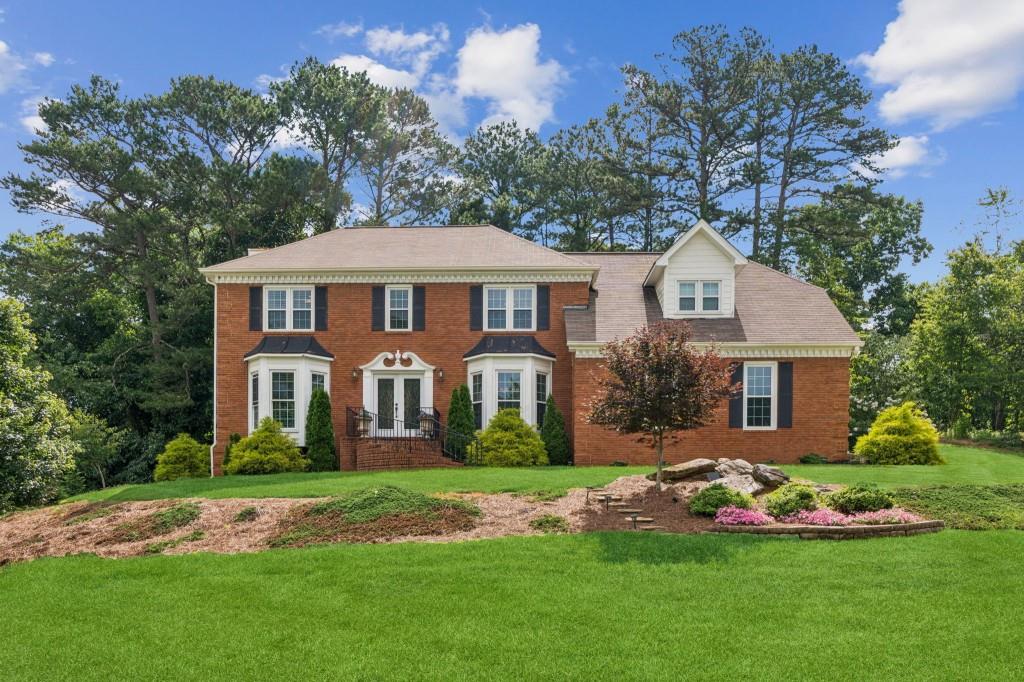 Introducing this stunning, remodeled, traditional home offering an ideal blend of style, functionality, and privacy. Located within walking distance of the Sugar Hill Corners Shopping Center and just minutes from Downtown Sugar Hill, Downtown Suwanee, and Historic Downtown Buford. The double front doors invite you into a foyer/entry way with an abundance of natural light and where the updates and modernizations become apparent in this clean and well-appointed home. The floorplan seamlessly connects the Spacious Family Room to the Kitchen featuring White Cabinets, Beautiful Brick Backsplash with Under-Cabinet Lighting, New Stainless-Steel Appliances, and White Farm Sink at a Window overlooking the Large Back Porch and Private Backyard. Upstairs you will find a Loft/Media Room and 3 Bedrooms including the Spacious Primary Suite with plenty of Sitting Room, Bath with Two Separate Vanities, Large Shower with Separate Garden Tub, and a Large Primary Closet with Custom Shelving. The Backyard is Private and Peaceful making it an awesome place for gatherings while taking in the natural beauty of the trees behind the home. Schedule your showing today!