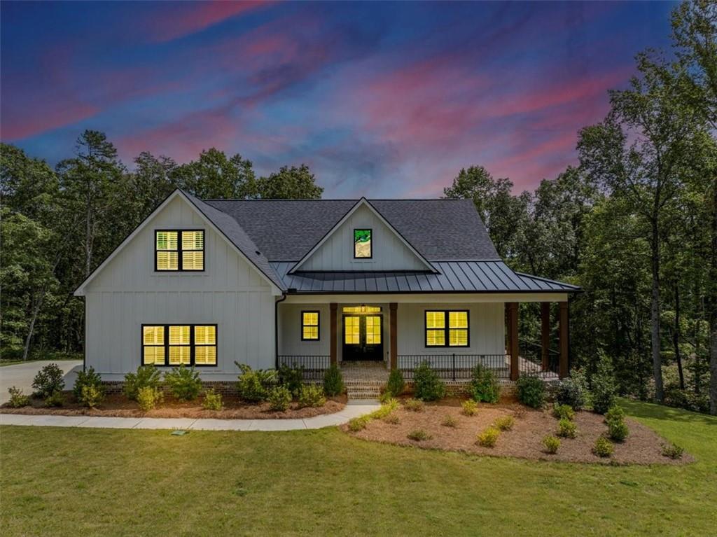 Step into refined elegance at this stunning Ball Ground residence. Designed with sophistication and comfort in mind, this home features soaring
ceilings, expansive windows, and a seamless open layout that exudes modern luxury. The chef’s kitchen is a true centerpiece, boasting quartz
countertops, custom cabinetry, premium appliances, and a statement island ideal for entertaining. Retreat to the lavish owner’s suite with its spa-like
bath, complete with soaking tub, glass-enclosed shower, and designer finishes. Spacious secondary bedrooms and thoughtfully appointed living areas
provide both comfort and style. Outdoors, enjoy a beautifully landscaped setting with ample space for private relaxation or elegant gatherings. Ideally
located near charming downtown Ball Ground, this home offers the perfect balance of luxury living and everyday convenience.