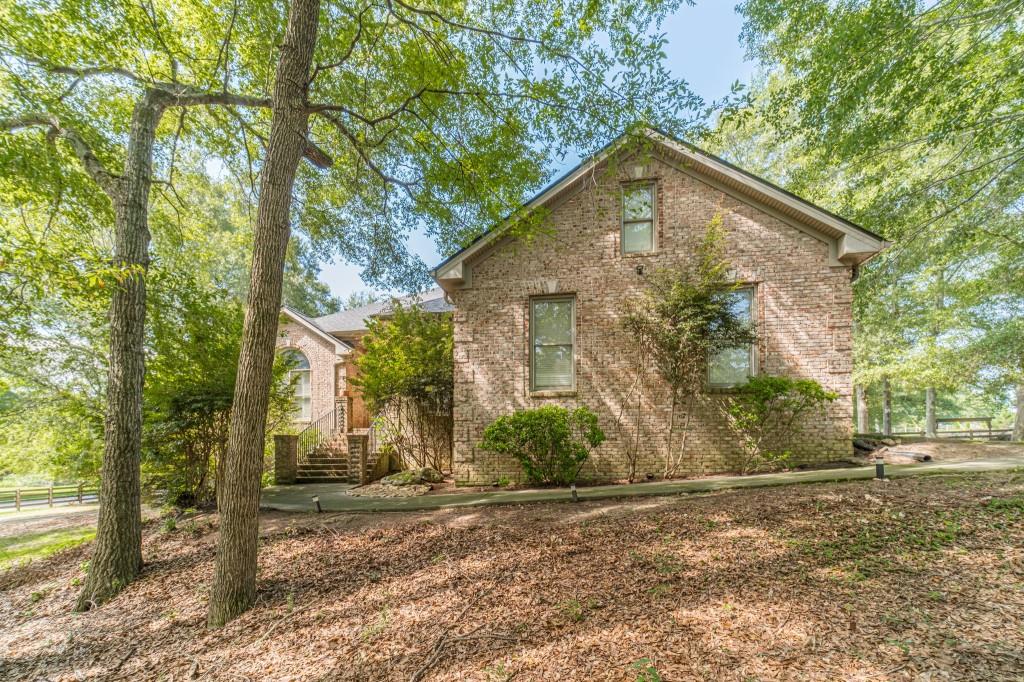 Welcome to this one-of-a-kind ranch nestled on a sprawling 2.1-acre lot. This spacious 5-bedroom, 3.5-bathroom home offers a life of comfort and tranquility within the coveted Loganville High School cluster. As you step inside, you'll be greeted by a generous floor plan that features an oversized Owner's Suite on the main level, complete with a gigantic walk-in closet, dual vanities, and a jetted tub. The split bedroom plan ensures privacy and convenience for all members of the household. HUGE bonus room upstairs, perfect for entertainment, a home office, or a cozy family retreat. Additionally, the finished Basement Apartment is an absolute gem offering a full kitchen, bathroom, bedroom, its own private driveway, garage, and patio - ideal for extended family, guests, or even as a rental opportunity. Stay comfortable year-round with a brand new HVAC system and enjoy peace of mind with a newer roof overhead. The back deck, oversized and adorned with a charming pergola, invites you to unwind or host gatherings. With a fenced backyard that offers endless possibilities, you can let your imagination run wild, creating your own personal outdoor oasis. And with a four-car parking space, there's plenty of room for vehicles and storage. Conveniently located to Shopping, Dining, Interstate 20, Athens & Atlanta. Don't miss the chance to make this your new home.