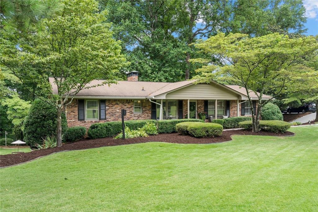 Welcome to the heart of Dunwoody! Tucked into one of Metro Atlanta’s most sought after areas, this home offers the perfect mix of suburban living and prime city access. Inside this beautiful four-sided brick ranch style home you’ll find a spacious owner’s suite with two additional bedrooms and two full baths on the main floor. Enjoy a renovated kitchen with all new cabinets, large new island, refrigerator, and an added pantry which opens to a bright breakfast area. The cozy living and family rooms with two fireplaces offer the perfect place to relax and gather with family and friends.
Don’t miss the thoughtful improvements throughout this home—including new hardwood floors throughout, stylish new lighting, and fresh interior paint. A renovated secondary bathroom, modern sun blinds, and updated garage doors with power openers are additional improvements.
With a welcoming front porch, lush level yard, garden boxes, and a covered deck, this
.6-acre lot is your personal outdoor haven—lovingly maintained. The fully finished renovated basement with new laminate flooring is the ultimate flex space — whether you’re dreaming of a man cave, home gym, office, movie nights or a playroom with a private exterior entry. No HOA. Just minutes to premier retail and restaurant options in vibrant Dunwoody along with top-rated schools, Brook Run Park, local trails, Perimeter Mall, I-285 and 400, you’ll love the lifestyle that comes with this location!