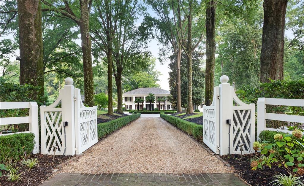 This is a very special opportunity to enjoy an equestrian estate...in Buckhead! An avenue of mature oaks lines the gated main entrance, leading to a luxurious home on 5.58 fenced acres. This stunning home features a classic style with modern European touches. The kitchens and master suite leave nothing to be desired, original and beautiful in every way. The finest cabinetry, finishes and home automation throughout. In addition to the spacious main home, there is a charming 2 br cottage. Property includes pasture, horse barn, covered riding arena, tennis, pool, and more!