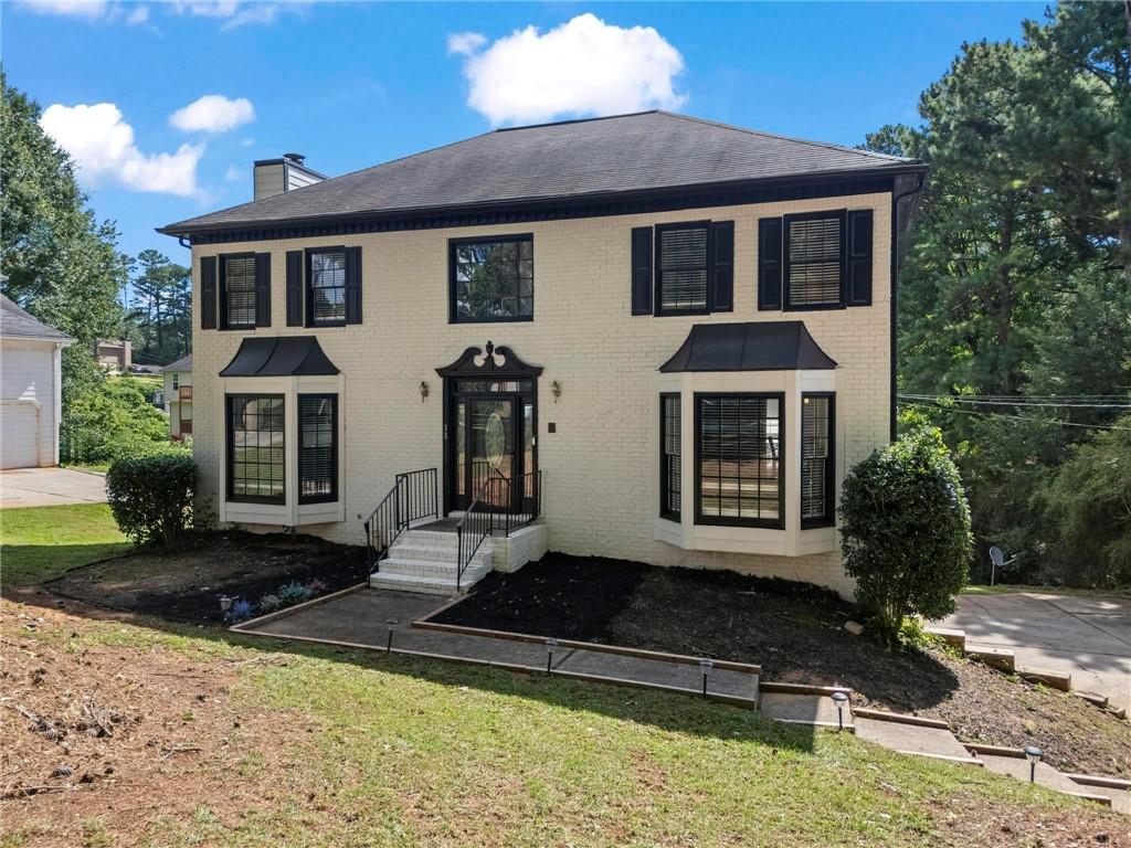 This fully renovated 4 bedroom, 2.5 bath home, offers over 3,100 square feet of living space and is located in the well established, NON-HOA tennis community of Brookglen. Step inside and you are welcomed by an inviting foyer. To the right is the spacious formal living room (with a bay window) and a separate formal dining. The modern, eat-in kitchen features stone countertops and a full stainless steel appliance package that remain with the home. Off from the kitchen is the sun-filled family room, with a bay window (at the front) and floor-to-ceiling windows overlooking the backyard. On the upper level, you will find an open landing with a large window that floods the space with morning light. The large master bedroom is directly to the right and offers peace and quiet away from the secondary bedrooms. With a spa-like ensuite and walk-in closet, it is the perfect retreat after a long day. Down the hall, 3 bedrooms and a full bath are tucked away in their very own corridor--a literal "kids zone," if you will. The laundry is conveniently located in the hallway and completes the upper level beautifully. The lower level features a finished, walk-out basement and oversized 2-car garage with plenty of storage space. Located only minutes from grocery stores, schools, pharmacies, gas stations, parks, restaurants, and interstates I-20 and I-285, this beautiful home is well maintained, move-in ready, and perfect for a growing family. Come tour your forever home TODAY!