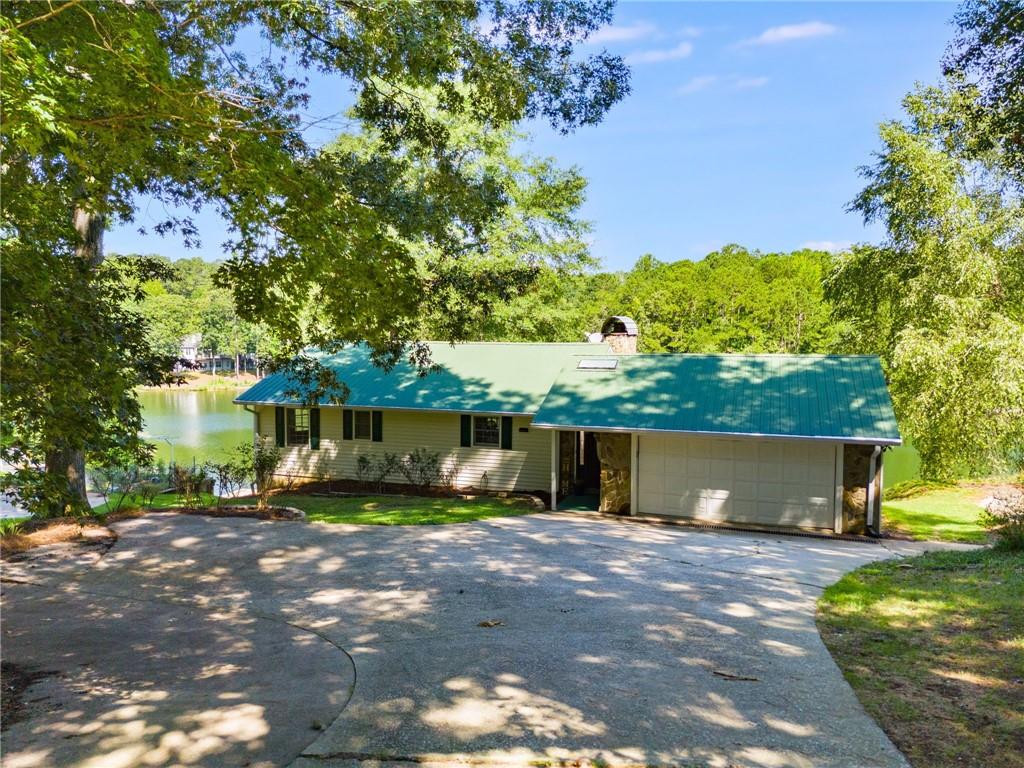 Stunning lake views in a gated community. This beautiful 3 bedroom, 2 bath home offers breathtaking lake views from every room, providing a tranquil backdrop to daily life. Located in a desirable gated community, the home features an open floor plan, perfect for entertaining. The main level boasts a spacious family room with a cozy fireplace, two generously sized bedrooms, and a large screened porch to enjoy the outdoors year-round. The finished basement provides even more space, with a large bedroom featuring a walk-in closet, a cozy den with its own fireplace, and a door leading to a walkout terrace with a spacious patio with the most amazing view of the lake. There is also a flex space that could be a perfect office, gym, game room, whatever you want to make it. Located in the amenity-packed Fairfield Plantation, this home offers access to two lakes, including a BEACH, two swimming pools, 3 lighted tennis courts, pickleball courts, a golf course, hiking trails, and a recreation center featuring a game room, a workout facility, and more. Enjoy year-round dining at the clubhouse or marina restaurant in this gated community with 24-hour security. A true retreat in a private setting!