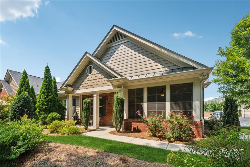 Welcome to The Orchards of East Cherokee! Enjoy the privacy of this quiet wooded corner in a sought after active adult community. Many builder upgrades, including beautiful trim, trey ceilings, chair rail and custom built-in cabinets in the great room, custom built ins in the pantry, master closet and laundry room. The kitchen features an extra wall of cabinets, stainless steel appliances and granite counter tops. Hardwood floors in the kitchen, dining and living rooms. Relax and enjoy your morning coffee while taking in the natural view in the comfortable three season room. This community offers a maintenance-free lifestyle, with the HOA maintaining lawn care, painting, and roofing. Community includes a clubhouse with a fitness area and kitchen adjacent to the community pool. Its prime Woodstock location is close to dining, shopping, and the convenience of the public library and Northside Cherokee hospital.