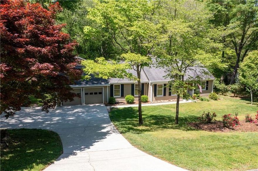 LOCATION, LOCATON, LOCATION! This ranch home is walking distance to downtown Alpharetta. Remodel this ranch home or build your dream home on this spacious, level .82 acre lot in one of Alpharetta's most desirable neighborhoods. The kitchen opens to the eat in area. The formal dining room is ready to host your dinner parties. The floorplan continues with a welcoming family room and a living room that would be perfect as an office, play room or den.  The main floor boasts the primary suite, two additional bedrooms, hall bathroom, and an oversized laundry room with a pantry, and ¾ bath. There is 4th bedroom and bathroom upstairs. You will enjoy spending time in your shop. Enjoy fine dining, boutique shopping, exciting community events, farmers market, and world-class entertainment at the nearby Ameris Bank Amphitheater. Whether envisioning a custom-built home or looking for a prime investment opportunity, this property provides the perfect canvas for your plans. This community embodies the charm and energy of Alpharetta’s thriving downtown atmosphere. Seize this opportunity to bring your vision to life!