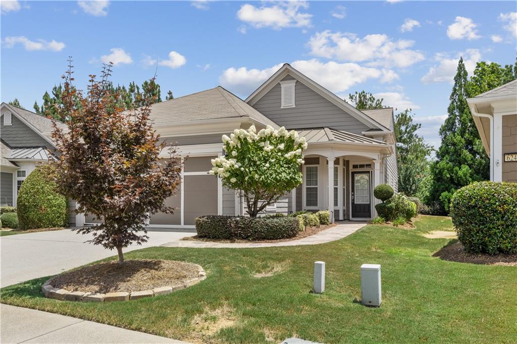 Welcome to 6241 Greenstone Circle, a sought-after Pine Spring patio home in the Village at Deaton Creek—a vibrant 55+ Del Webb community where resort-style amenities meet everyday convenience. Set on a quiet cul-de-sac with a convenient pocket park just across the street, the home greets you with a stamped, concrete flagstone walkway to the front entrance. Once inside, hardwood floors span the foyer, kitchen, and halls, while brand-new carpet cushions both bedrooms for a fresh, move-in feel. The rear-facing kitchen is open to the great room and features Corian® counters, a tiled backsplash, and stained cabinetry; a sliding door leads to a cozy, all-seasons screened porch overlooking a private patio with tree-lined backyard—no direct view into neighboring homes thanks to the higher elevation of this Lot.
Two generous bedrooms, two full baths, and a flexible office accommodate everything from overnight guests to creative pursuits. Fresh interior paint, new carpet (July), and a recently serviced HVAC system (June) ensure peace of mind. See the treasure trove of meticulous maintenance records; service tickets & receipts.While a forthcoming stepping-stone side walkway will be soon be installed in-between the homes on the right-side adding convenience and accessibility to the backyard and patio.
Beyond your doorstep, the Village at Deaton Creek delivers an “adult summer-camp” experience with vibrant energy and activity. Residents enjoy indoor and outdoor pools, a clubhouse, fitness center, tennis, pickleball, bocce, miles of walking trails, and more than 100 social clubs. Once you discover for yourself how vibrant—and easy—55+ living can be, you’ll start the “design” of your next chapter in style and comfort. Schedule your private tour today.