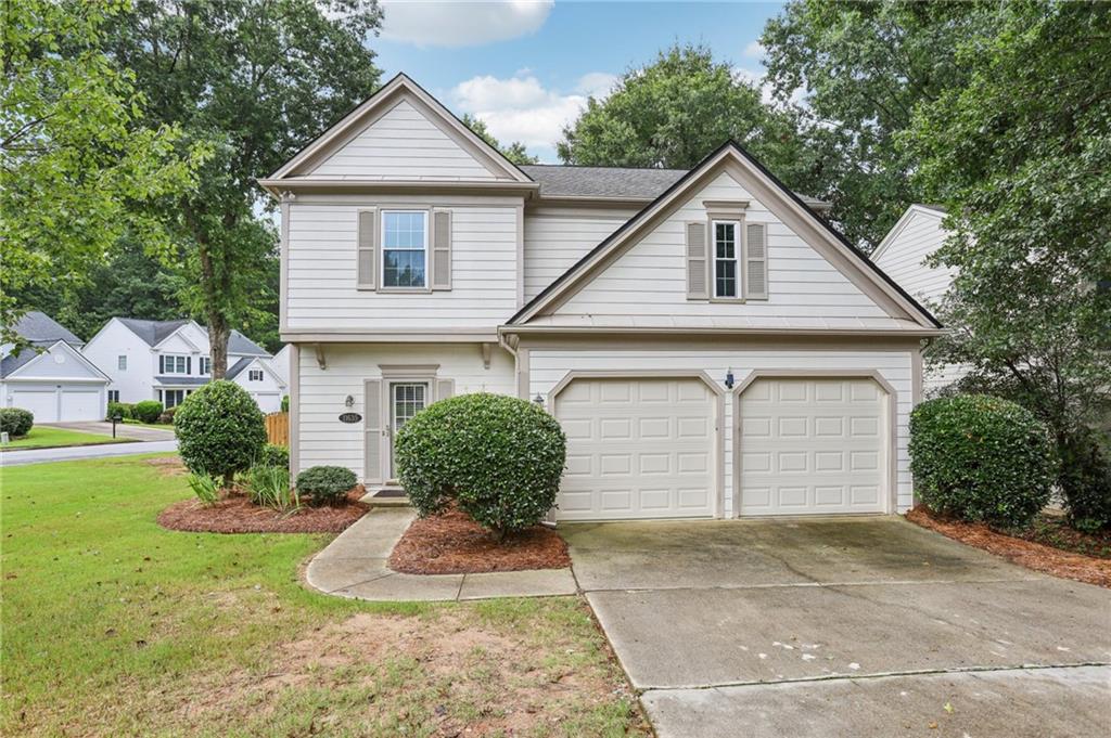 Spacious Corner Lot with Modern Upgrades & Community Amenities! Sitting on a huge corner lot with expansive green space and a sweeping front yard, this home impresses from the moment you arrive. Step inside to a soaring two-story foyer with rich hardwood floors that flow throughout the main level, including the bright and inviting living room with a cozy fireplace and abundant natural light. The updated kitchen is a chef’s dream—featuring white cabinetry, quartz countertops, tile backsplash, stainless steel appliances, modern lighting, and a sunlit eat-in breakfast area. The separate dining room overlooks the private backyard, perfect for relaxed meals or formal gatherings. A convenient half bath and laundry room complete the main level. Upstairs, wood floors continue throughout—no carpet anywhere! The spacious primary suite features vaulted ceilings and an updated en-suite bath with dual vanities, tile floors, a frameless glass shower, and a freestanding pedestal soaking tub. A large walk-in closet with a built-in organization system adds everyday convenience. Two additional generously sized bedrooms share a full hall bath with double sinks, offering space and comfort for everyone. Enjoy outdoor living in the fully fenced backyard with a patio slab—ideal for grilling, entertaining, or gardening! Neighborhood amenities include a resort-style pool with splash pad, tennis courts, playground, sports courts, and more. Don't miss your opportunity - book your tour today!